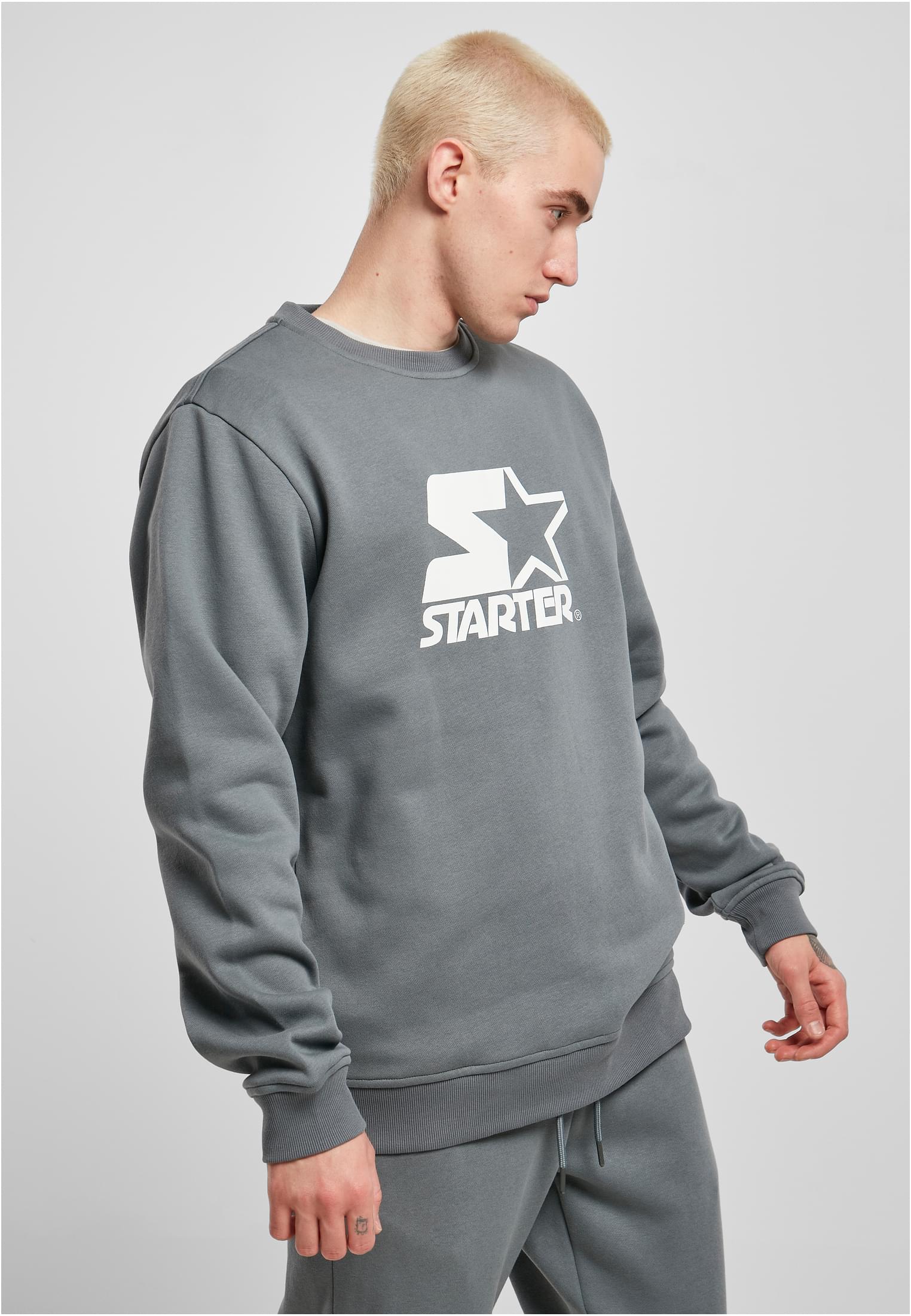 Men's Starter Logo Crewneck Sweatshirt featuring a large logo print on the chest, ribbed cuffs, and a round neck design in soft brushed fleece.