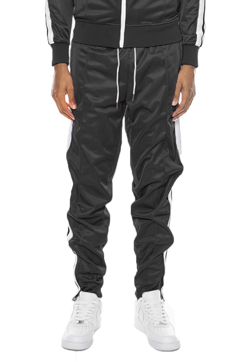 A pair of stylish striped tape track pants featuring an elastic waist, drawstring, ankle zippers, and pockets, displayed on a neutral background.