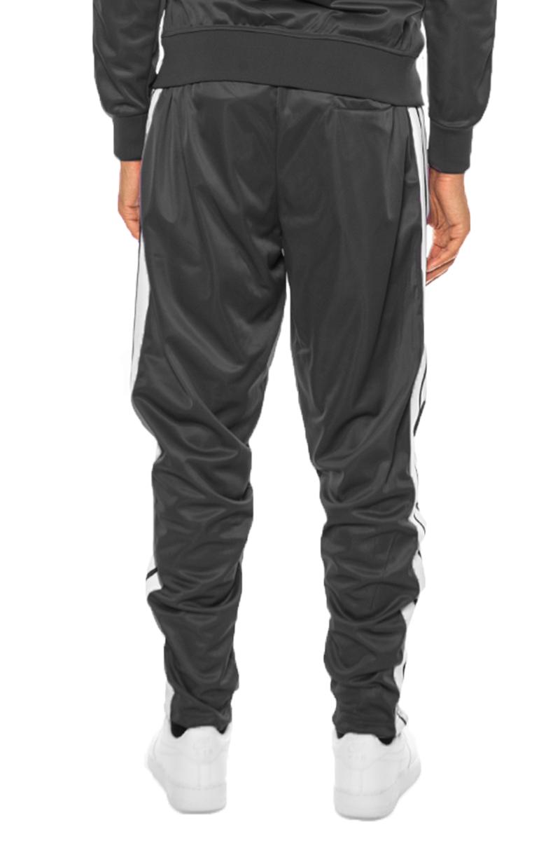 A pair of stylish striped tape track pants featuring an elastic waist, drawstring, ankle zippers, and pockets, displayed on a neutral background.