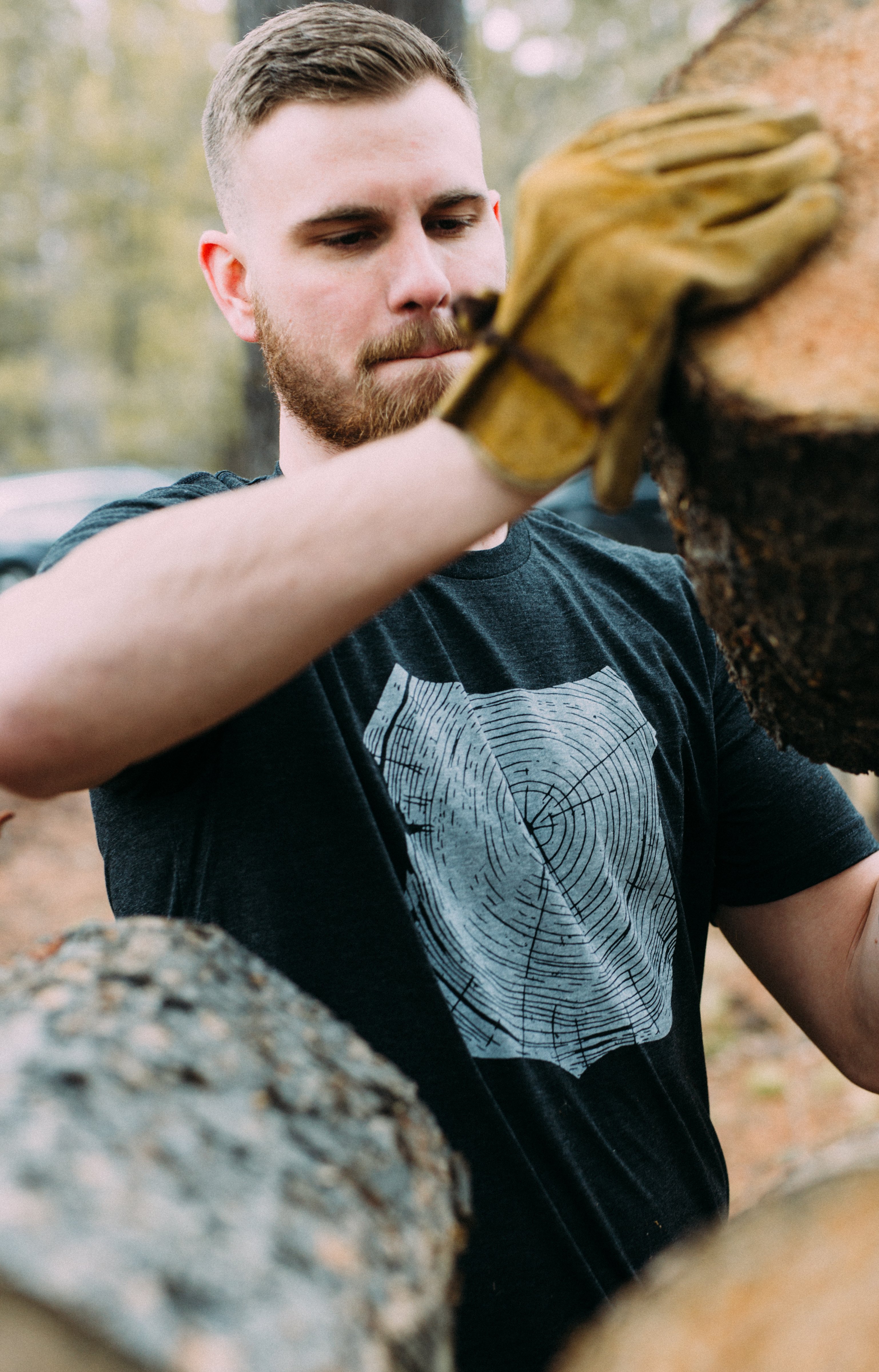 Charcoal Stump Tee featuring a hand-drawn forest design, made from a soft tri-blend fabric.