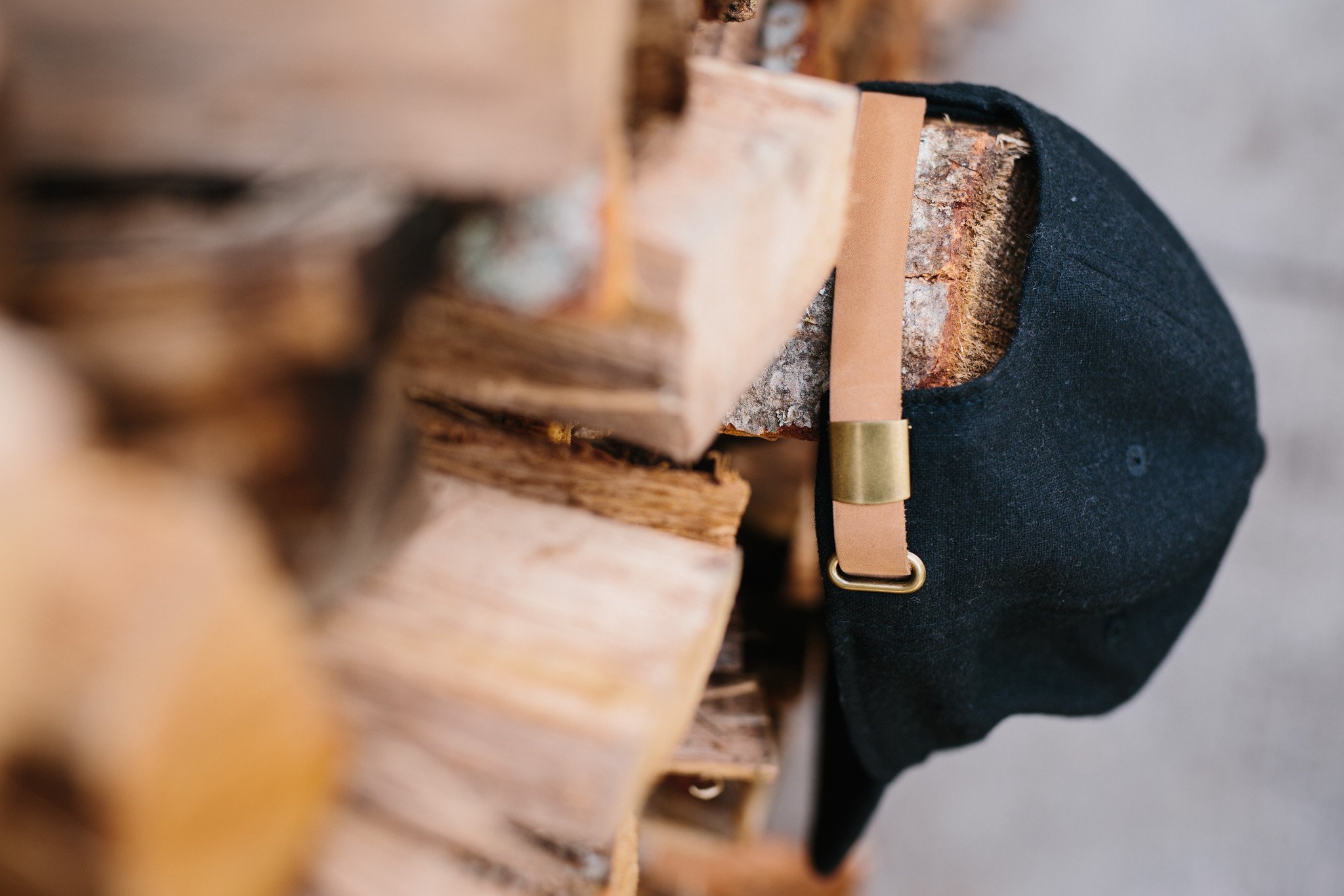 Tent Hat in black flannel featuring lightweight material, adjustable leather strap, and vintage baseball cap design.