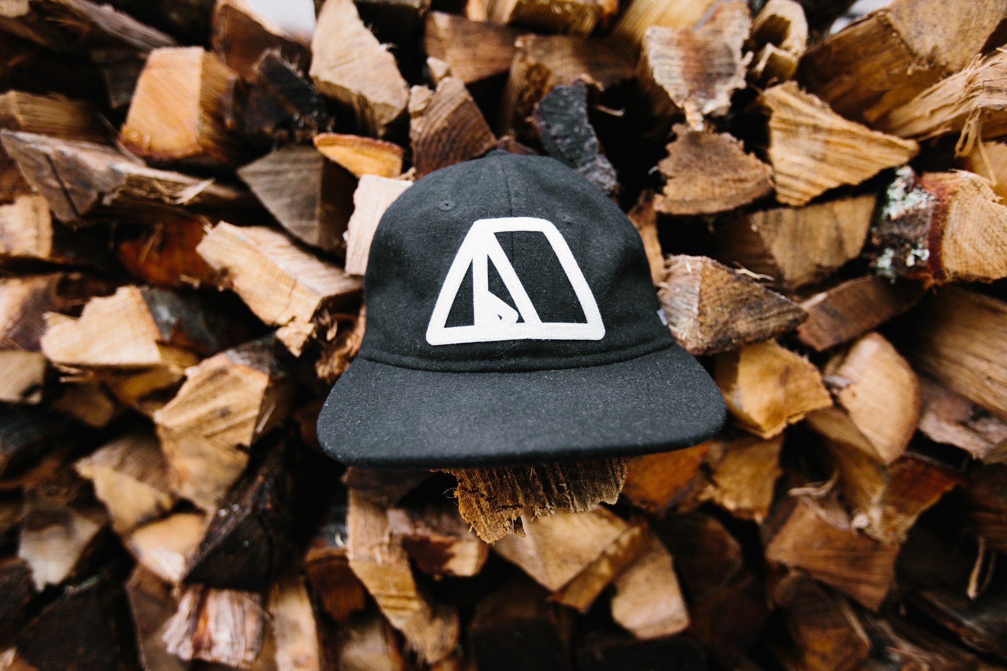 Tent Hat in black flannel featuring lightweight material, adjustable leather strap, and vintage baseball cap design.