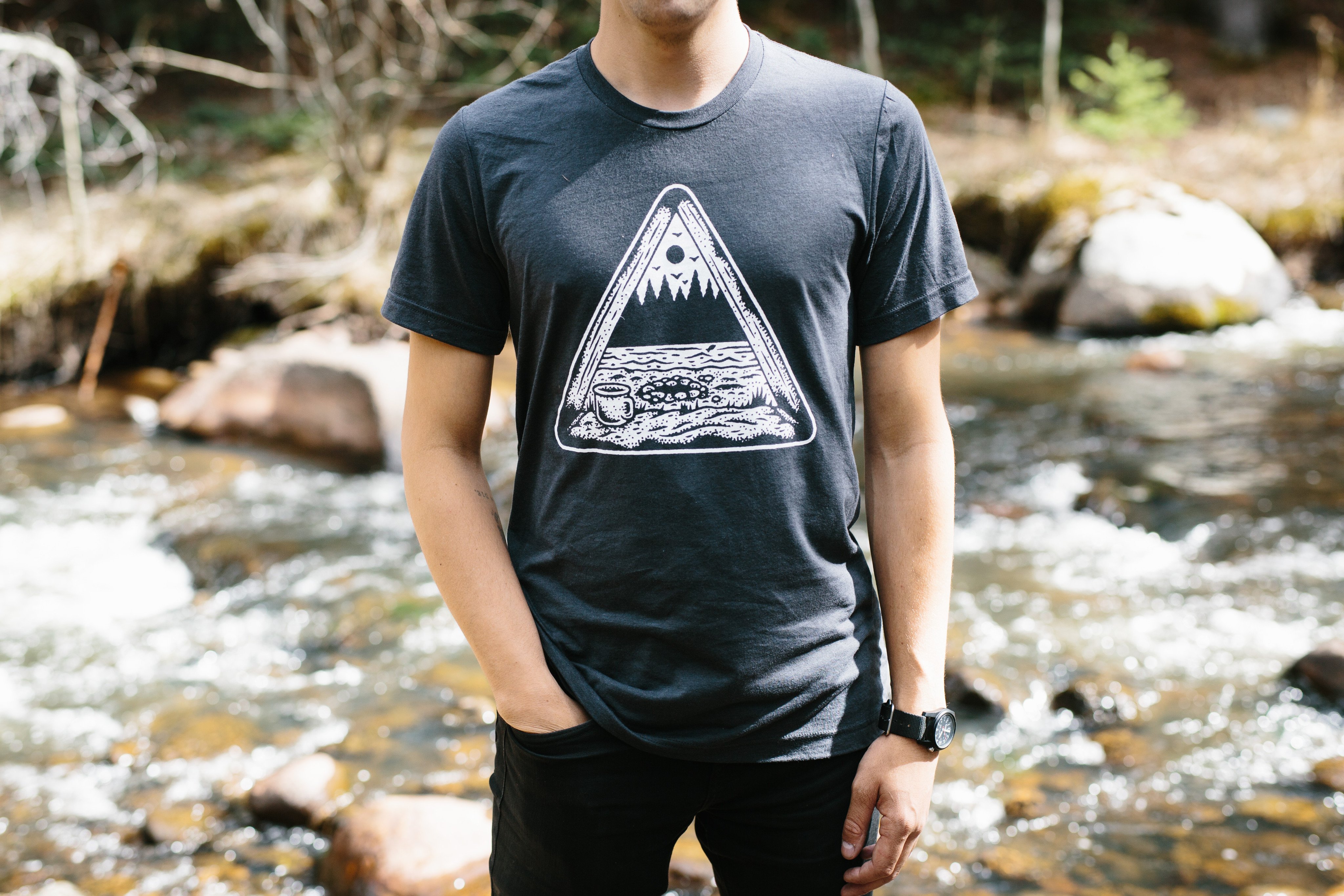 Dark gray Tent View Tee featuring a camping design printed in white water-based ink, made from a soft tri-blend fabric.