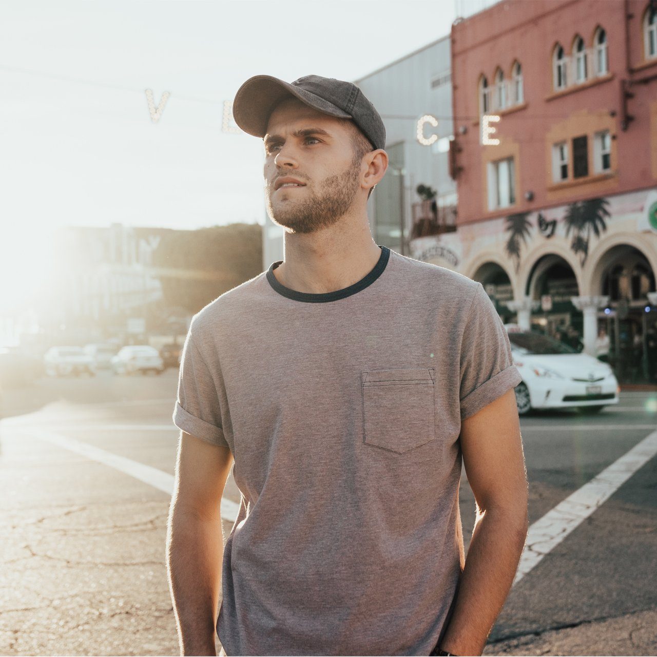 The Coachella Bundle featuring a striped ringer tee and a snow washed dad hat, perfect for summer outings.