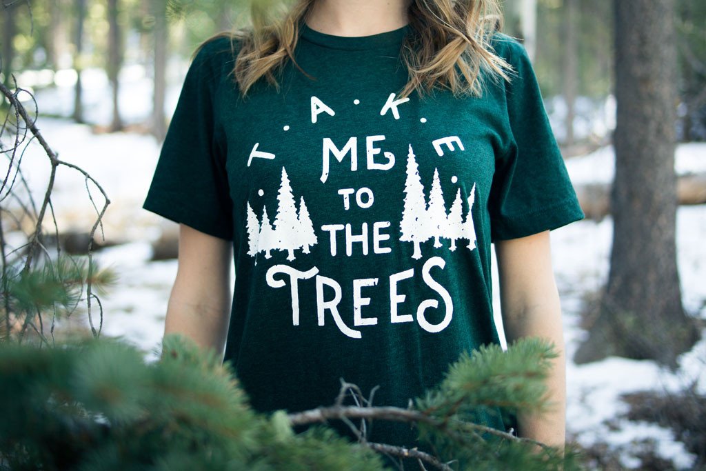 Emerald green Trees Tee featuring a nature-inspired design, hand screen printed with white water-based ink.