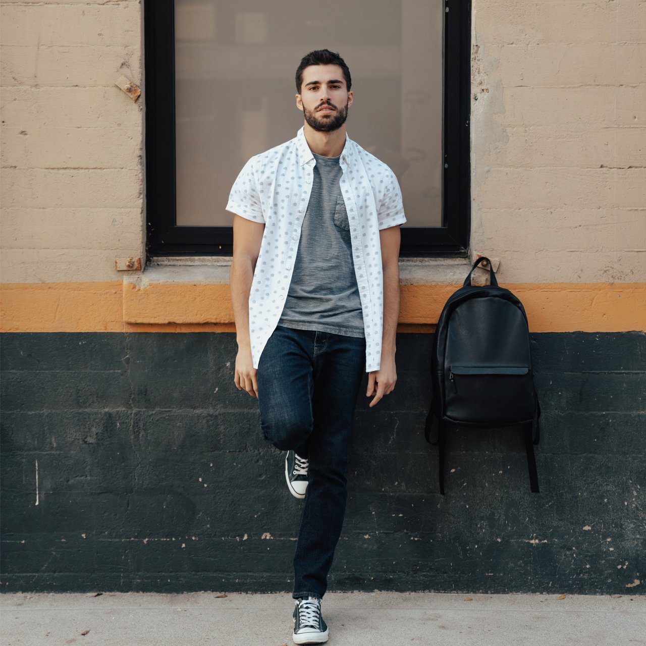 The Triple Play Bundle featuring a sleek vegan leather backpack, an all-over print button-down shirt, and a comfortable gray tee.