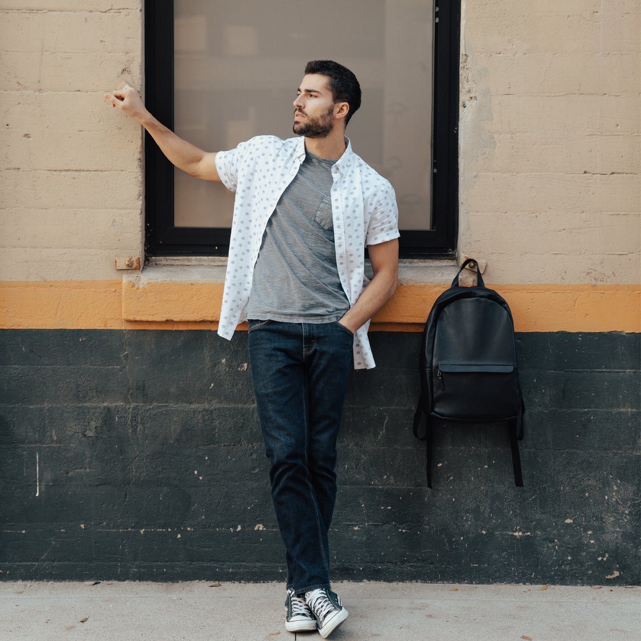 The Triple Play Bundle featuring a sleek vegan leather backpack, an all-over print button-down shirt, and a comfortable gray tee.