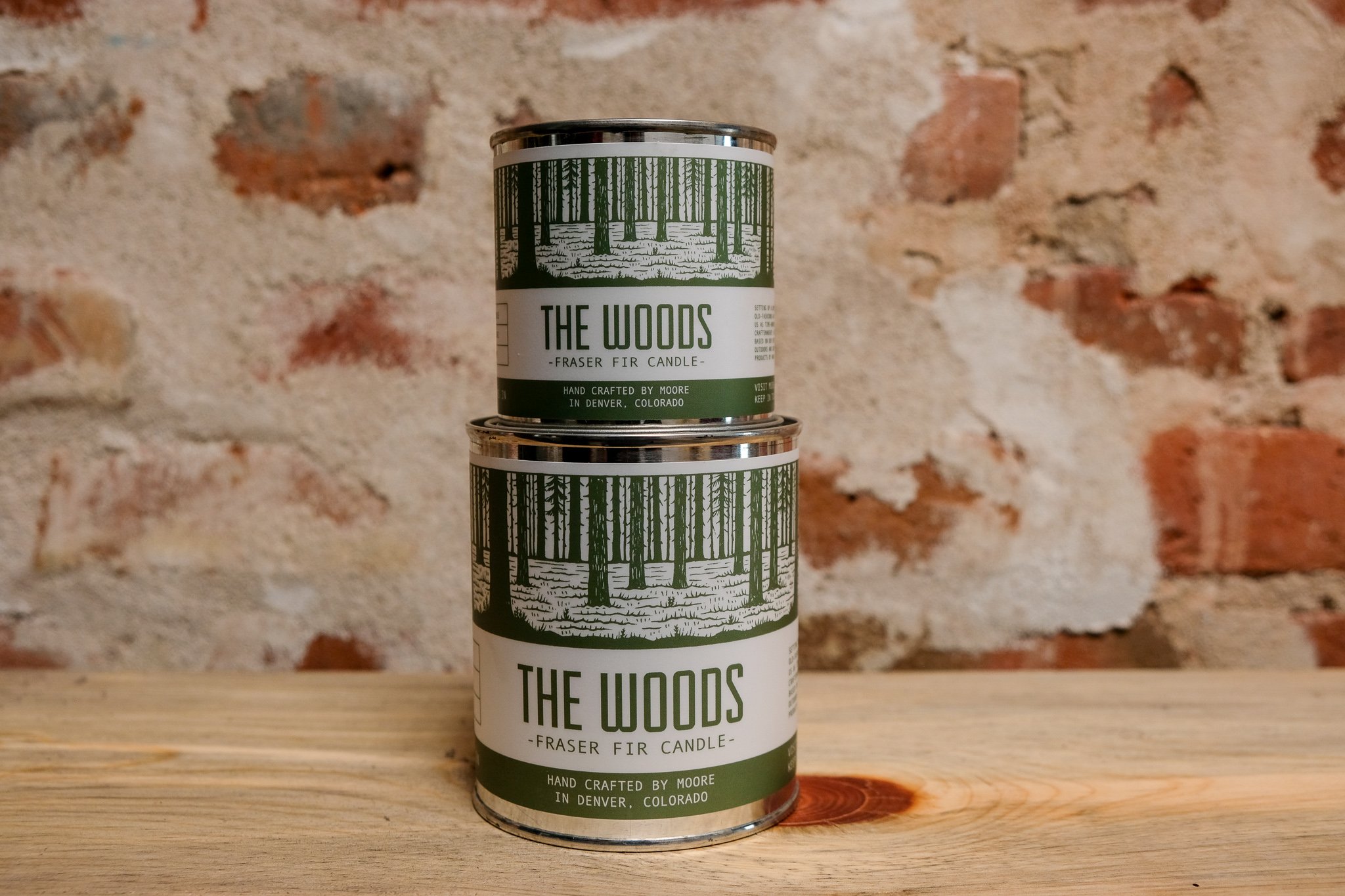 A beautifully handcrafted Woods Candle in a glass jar, showcasing its natural soy wax and elegant label inspired by the outdoors.