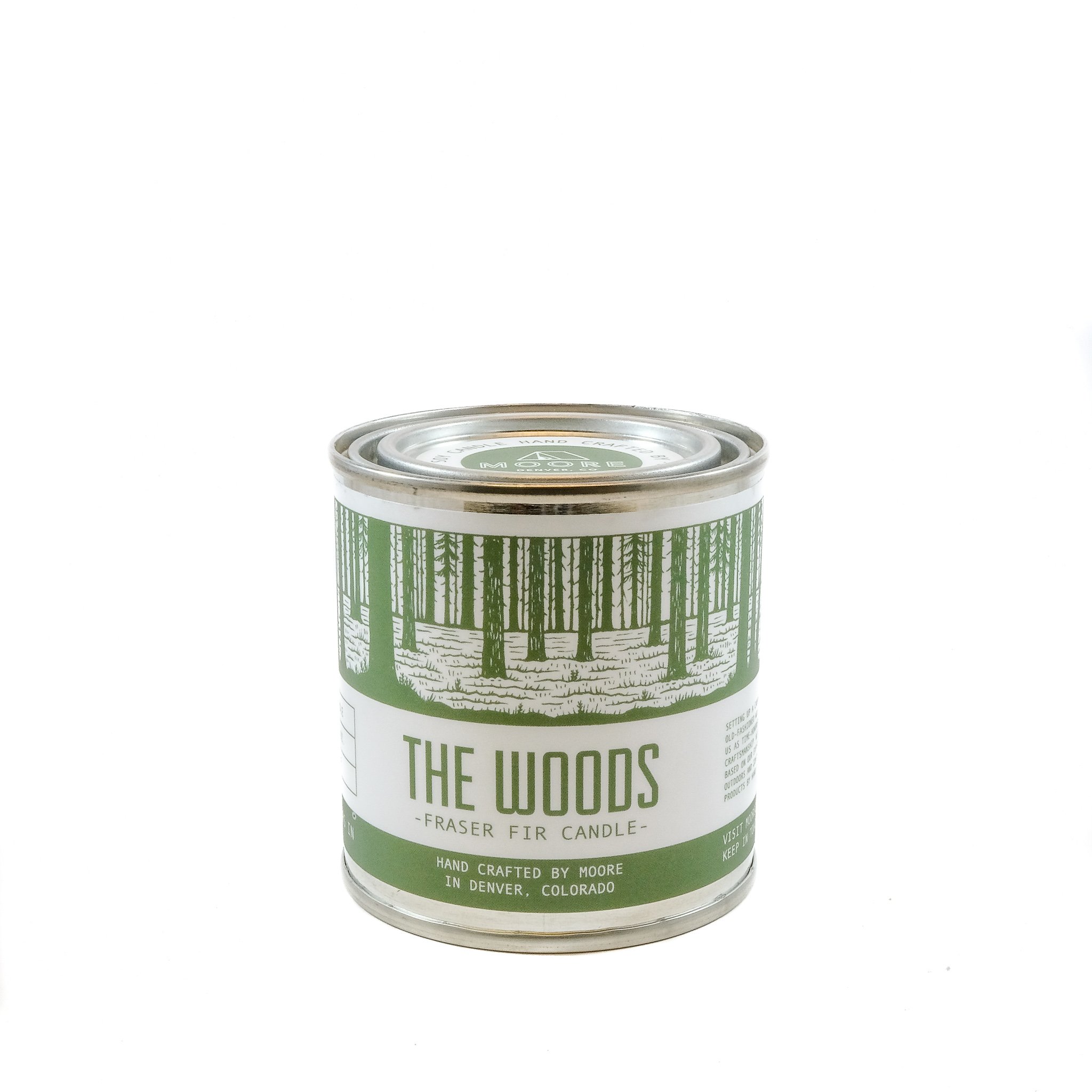 A beautifully handcrafted Woods Candle in a glass jar, showcasing its natural soy wax and elegant label inspired by the outdoors.