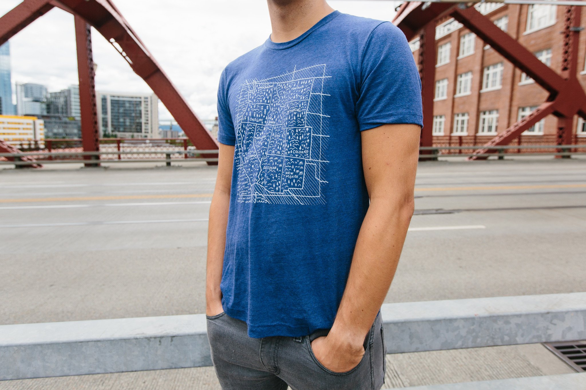 Navy Travel West Tee featuring white screen printed design, made from soft tri-blend fabric.