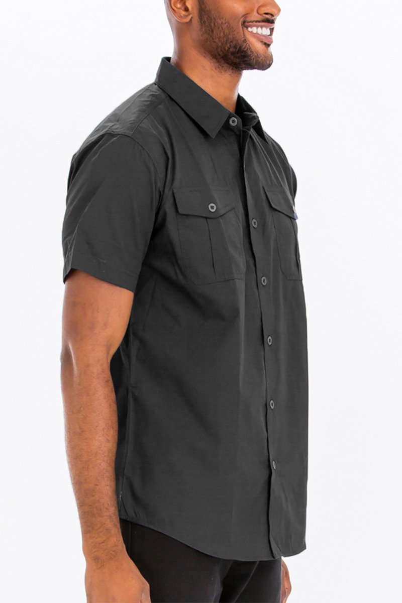 A stylish black two pocket button down shirt with short sleeves, featuring a round hem and button flap pockets.