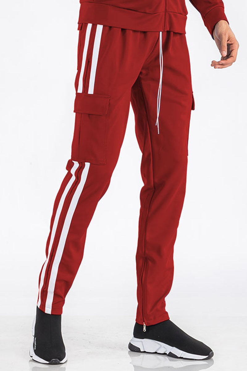 Two Stripe Cargo Pocket Track Pants featuring an elastic waist, ankle zippers, and Velcro closure pockets in a stylish design.