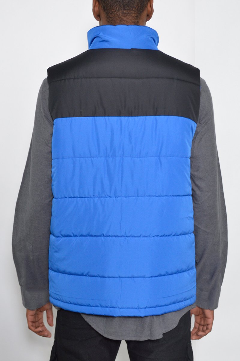 A stylish two-tone padded vest made of 100% polyester, featuring a modern design suitable for layering.