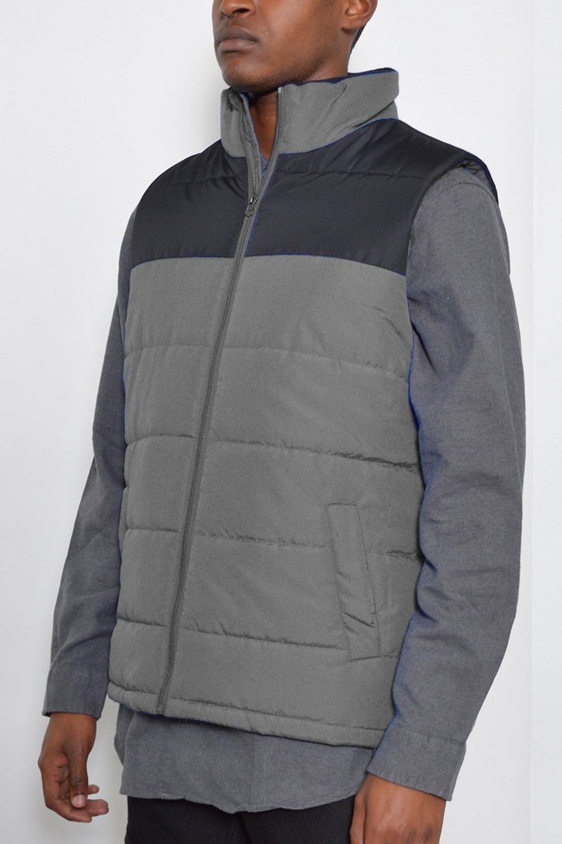 A stylish two-tone padded vest in a modern design, showcasing its lightweight and warm features.