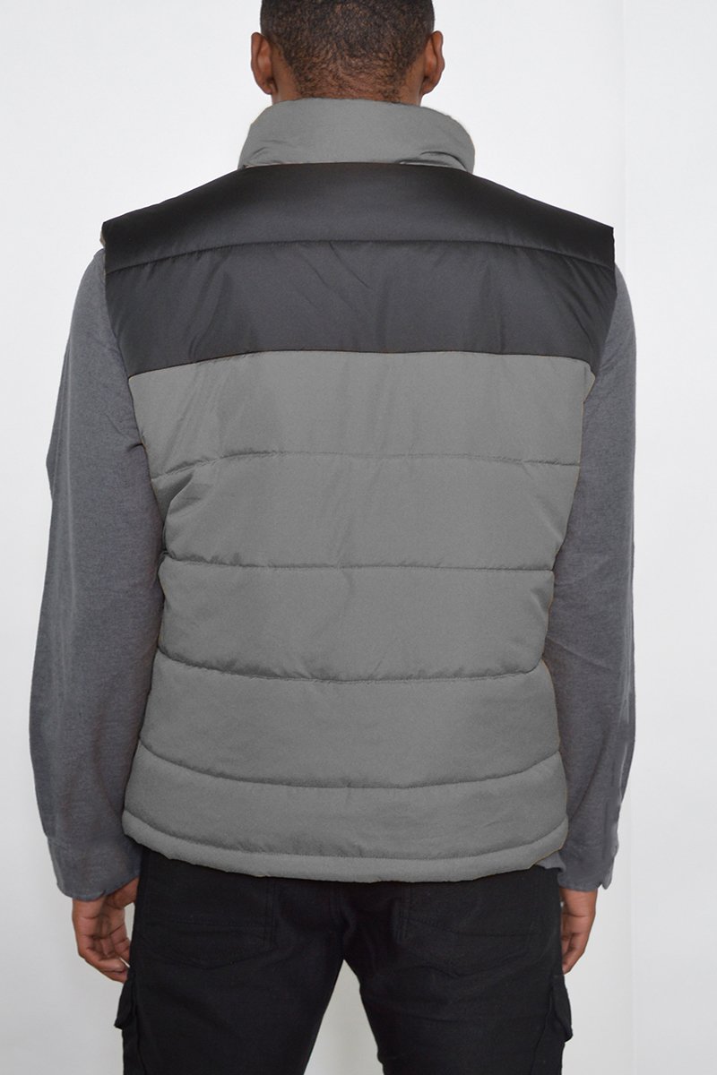 A stylish two-tone padded vest in a modern design, showcasing its lightweight and warm features.