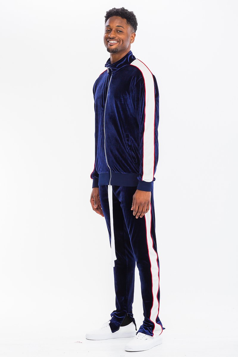 A stylish velour track set featuring a slim fit, hidden ankle zippers, and standard pockets, perfect for workouts or casual wear.