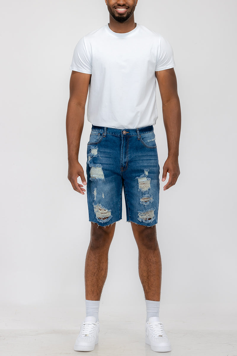 A pair of washed distressed denim shorts featuring a button closure waist and standard pockets, styled for a casual summer look.