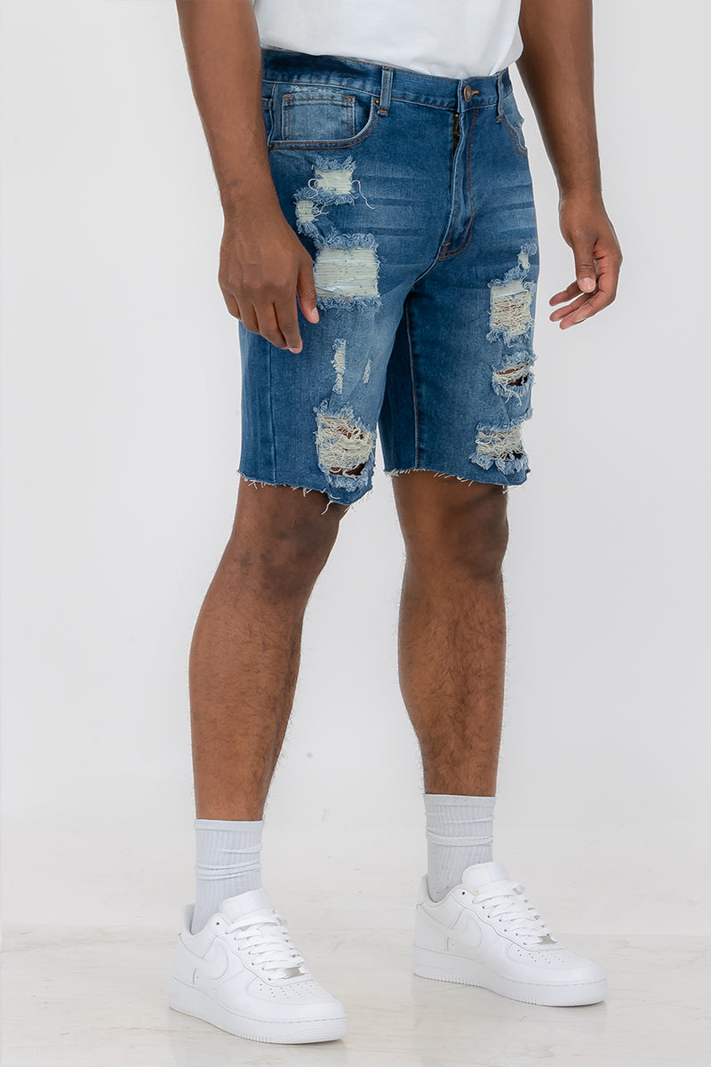 A pair of washed distressed denim shorts featuring a button closure waist and standard pockets, styled for a casual summer look.