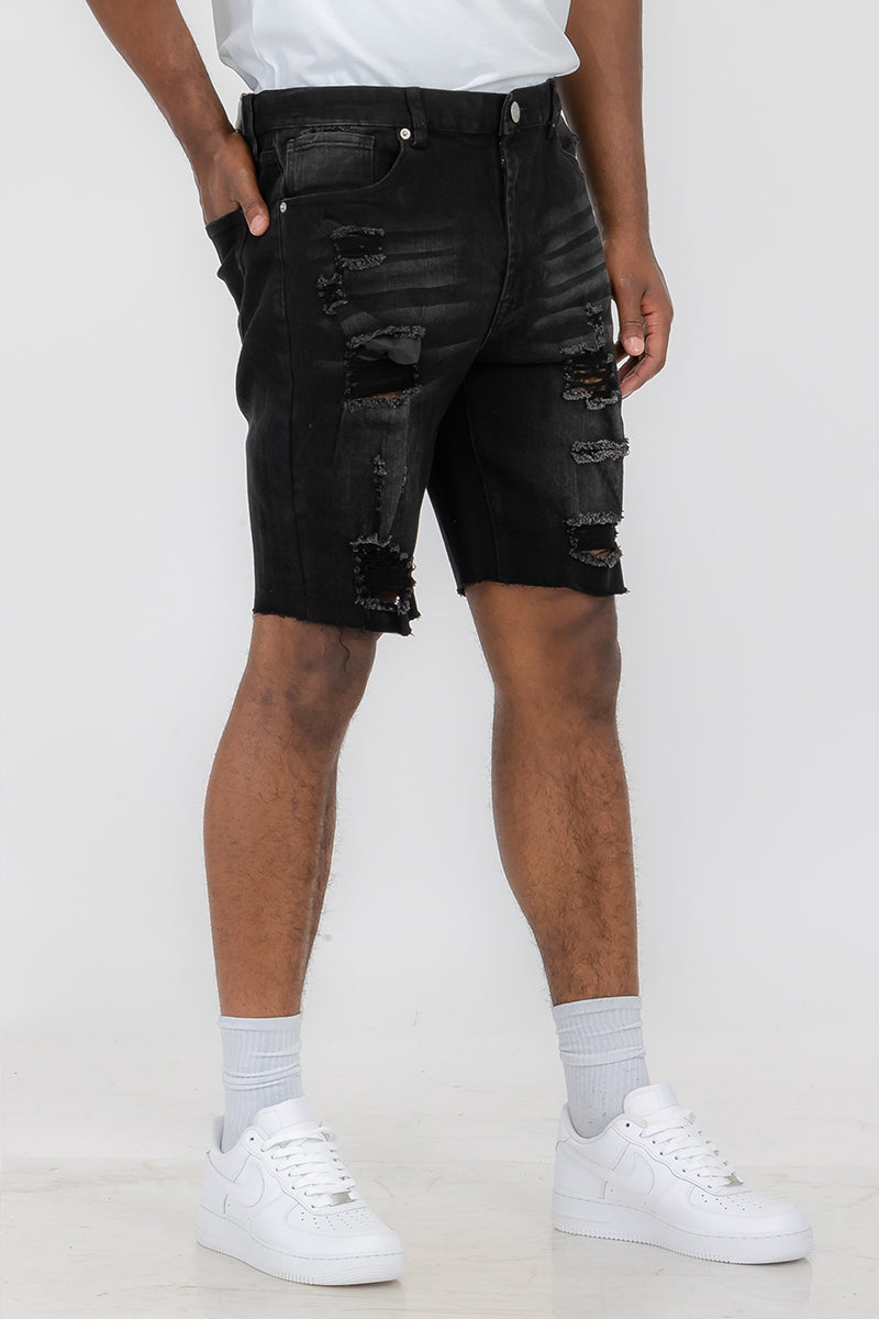 A pair of washed distressed denim shorts featuring a button closure waist and standard pockets, styled for a casual summer look.