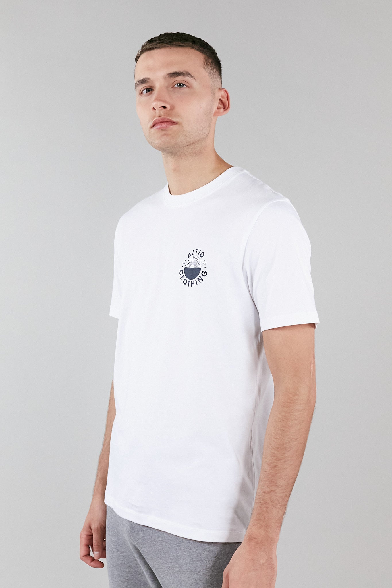 A stylish white graphic t-shirt made from 100% pure cotton, featuring a crew neck and an altid printed logo, perfect for versatile wear.