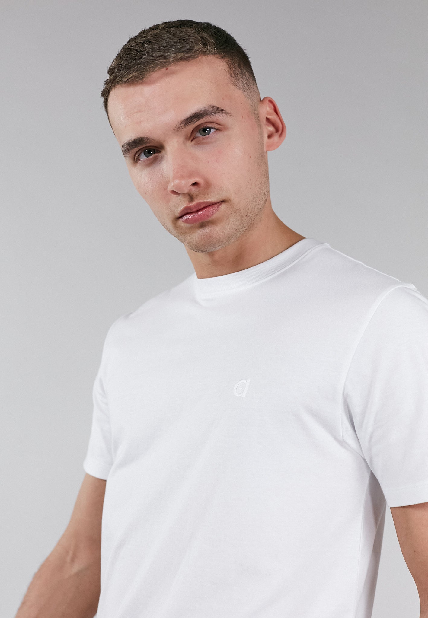 A soft touch white low carbon t-shirt made from 100% organic cotton with an embroidered altid logo.