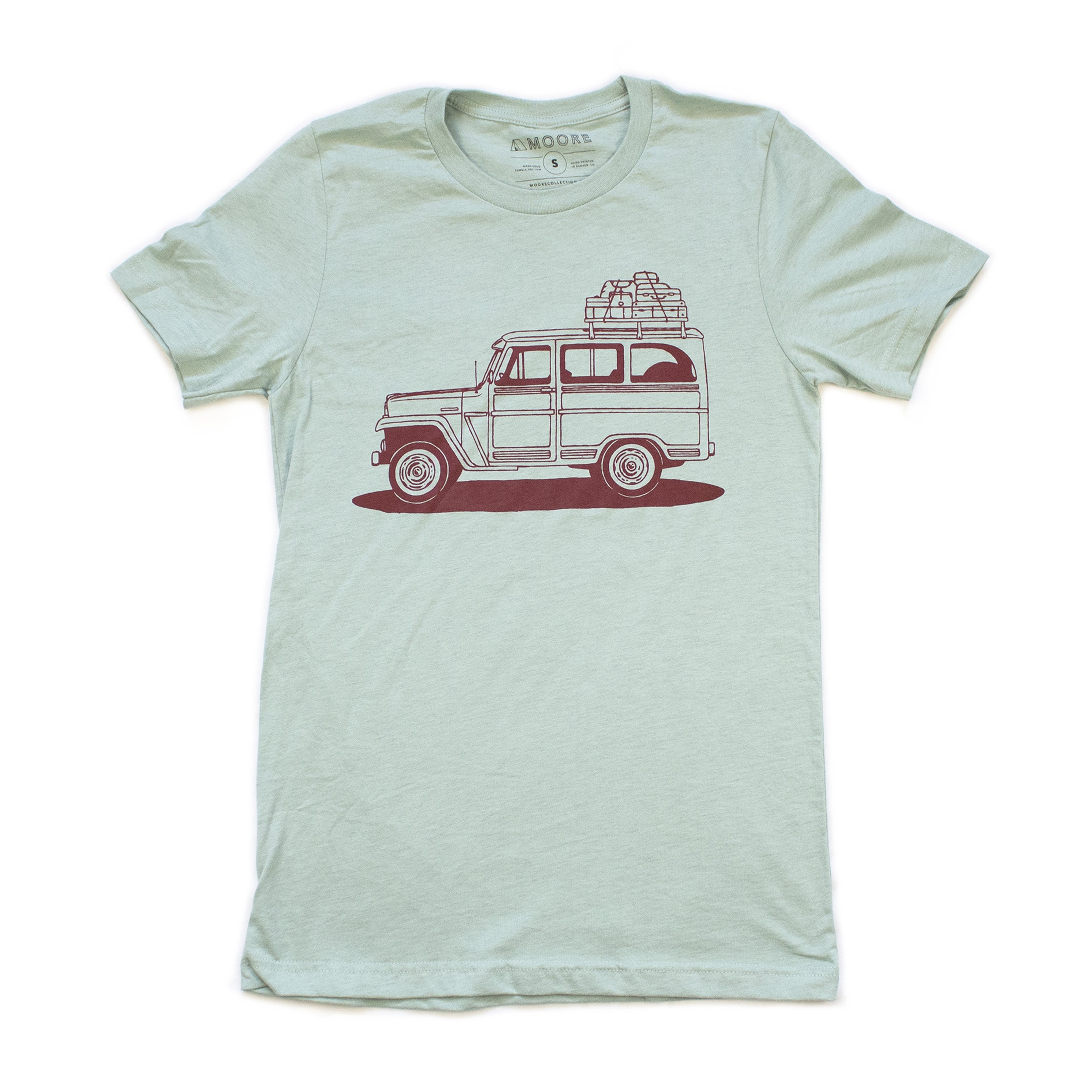 Willy Wagon Tee in dusty blue featuring a classic Jeep design printed in red water-based ink, made from a soft tri-blend fabric.