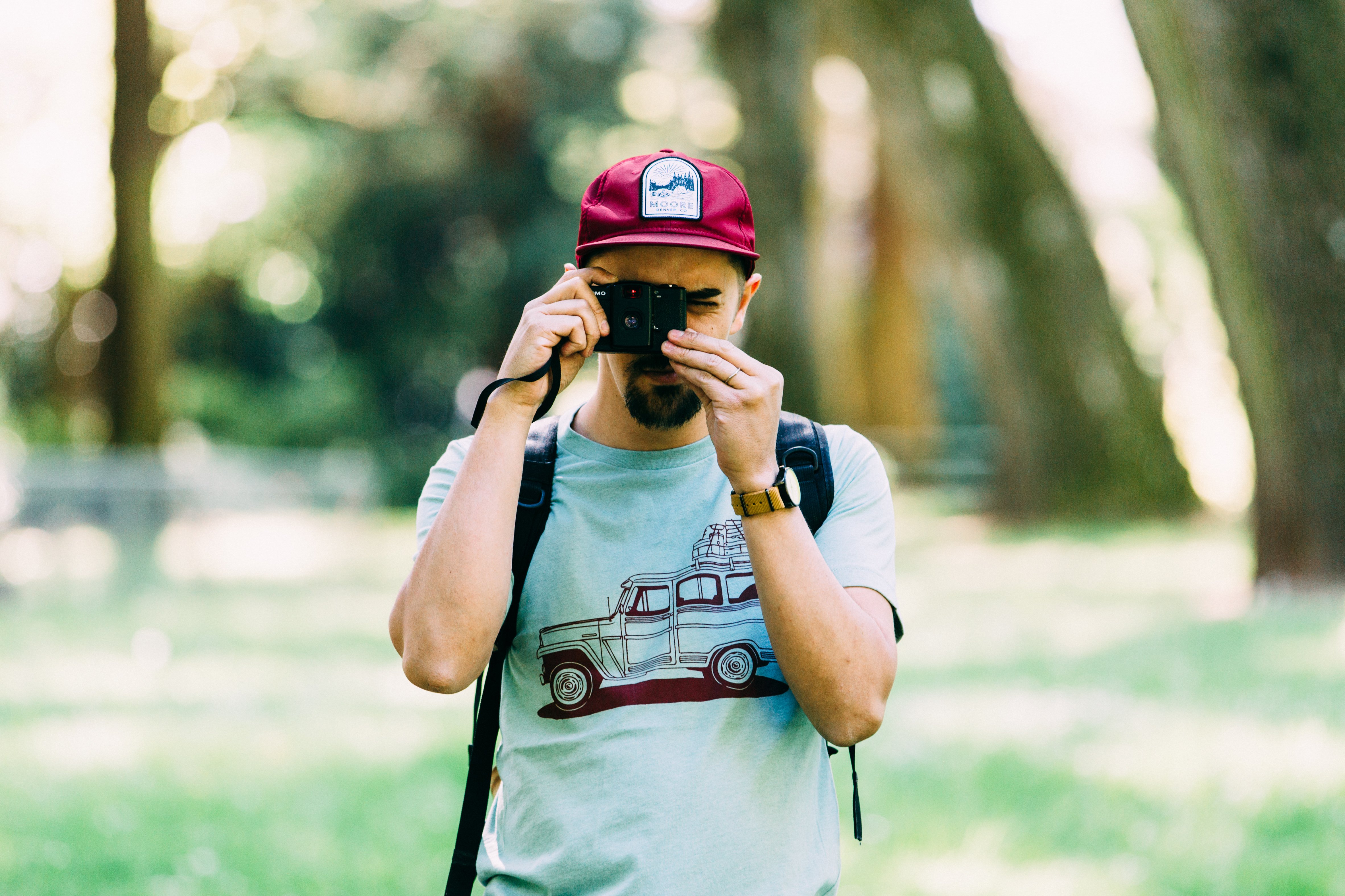 Willy Wagon Tee in dusty blue featuring a classic Jeep design printed in red water-based ink, made from a soft tri-blend fabric.