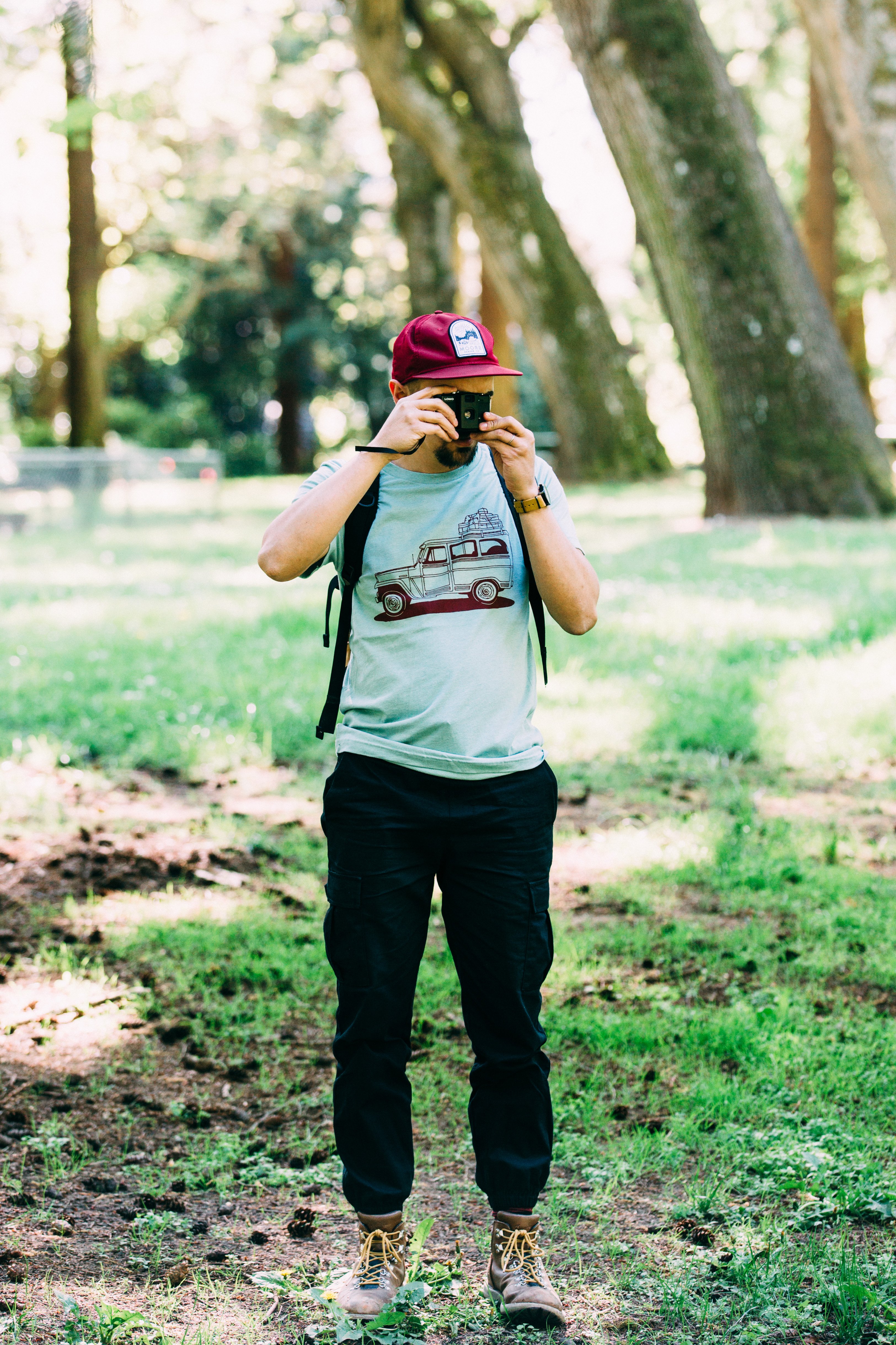 Willy Wagon Tee in dusty blue featuring a classic Jeep design printed in red water-based ink, made from a soft tri-blend fabric.