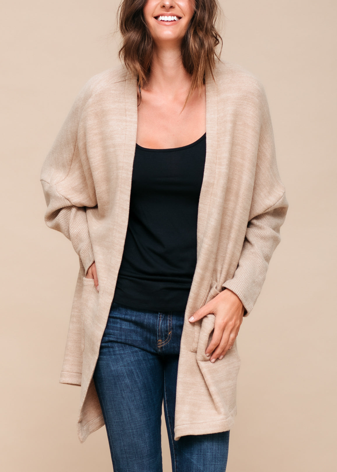 A stylish Women's Basic Cardigan in Camel color, showcasing its soft fabric and relaxed fit, perfect for layering.