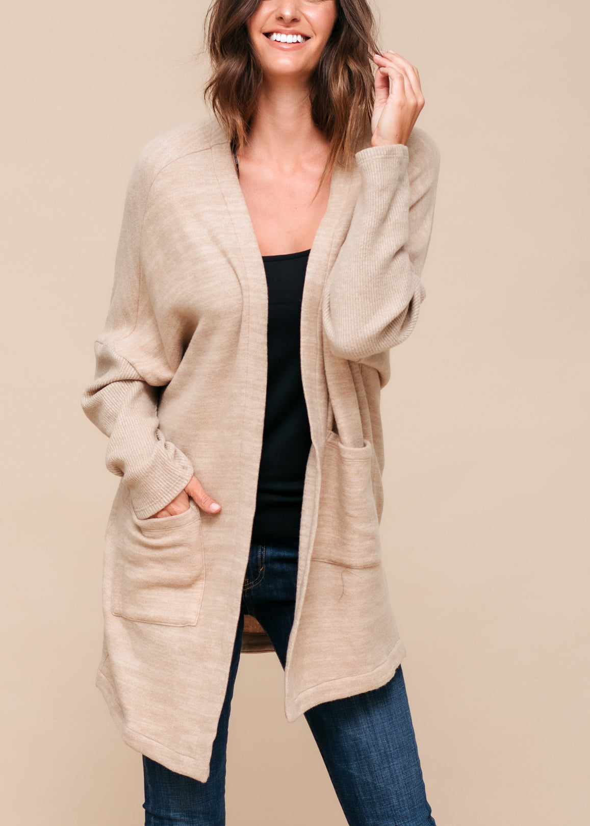 A stylish Women's Basic Cardigan in Camel color, showcasing its soft fabric and relaxed fit, perfect for layering.