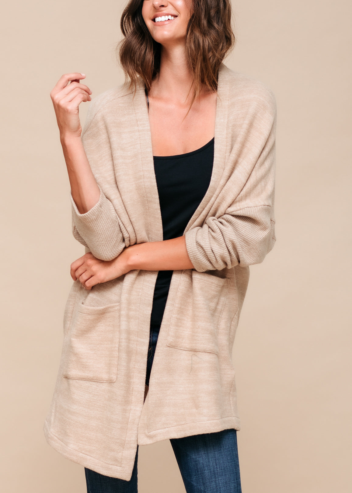 A stylish Women's Basic Cardigan in Camel color, showcasing its soft fabric and relaxed fit, perfect for layering.