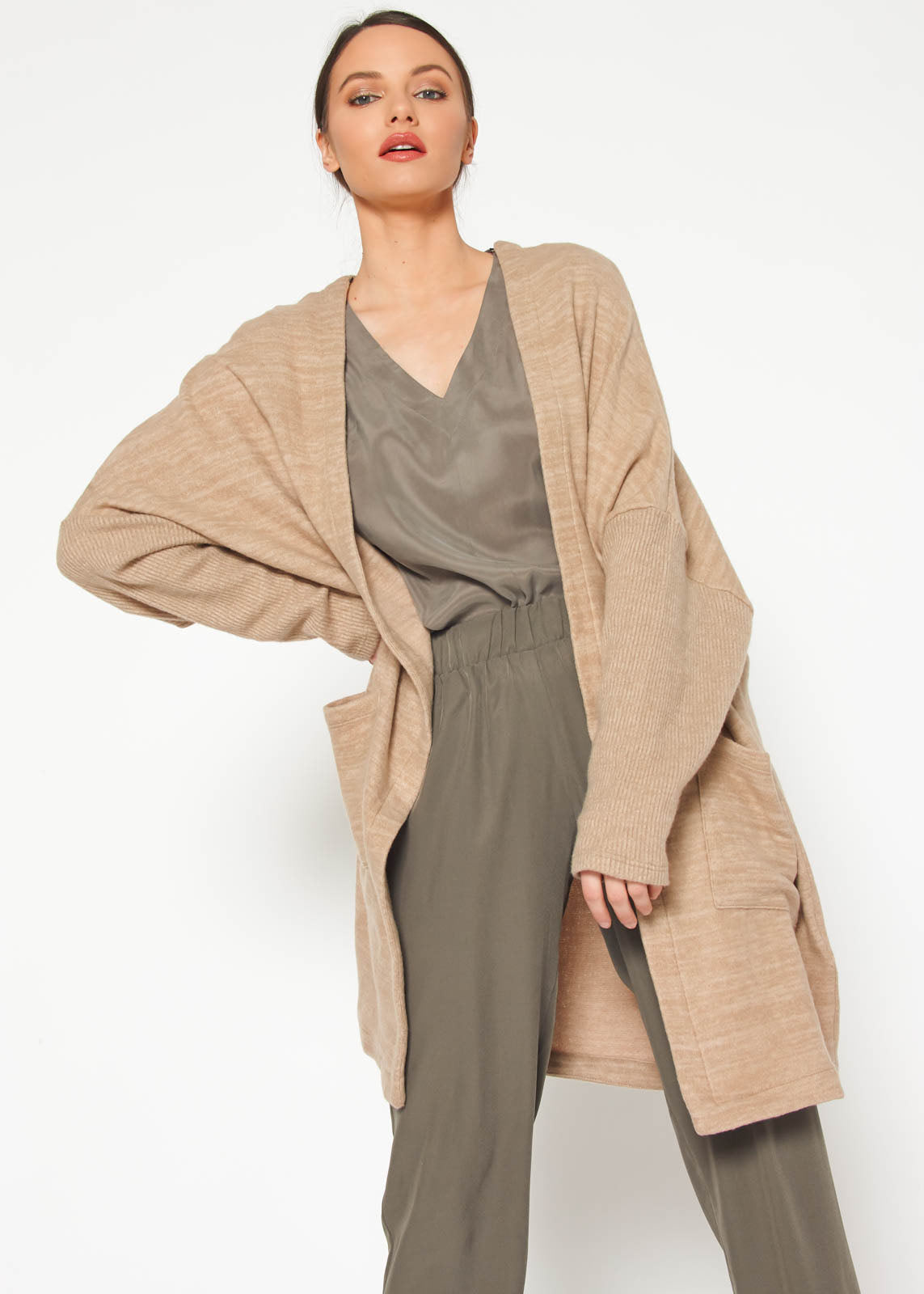 A stylish Women's Basic Cardigan in Camel color, showcasing its soft fabric and relaxed fit, perfect for layering.