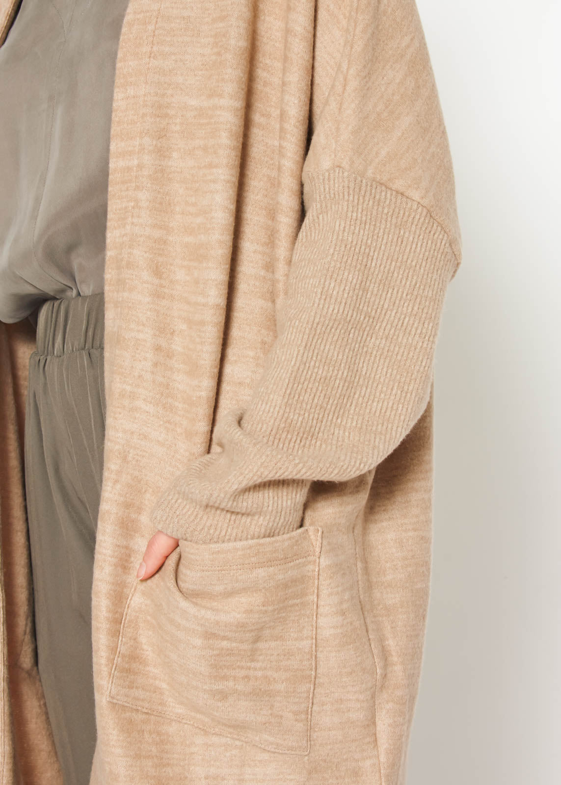 A stylish Women's Basic Cardigan in Camel color, showcasing its soft fabric and relaxed fit, perfect for layering.