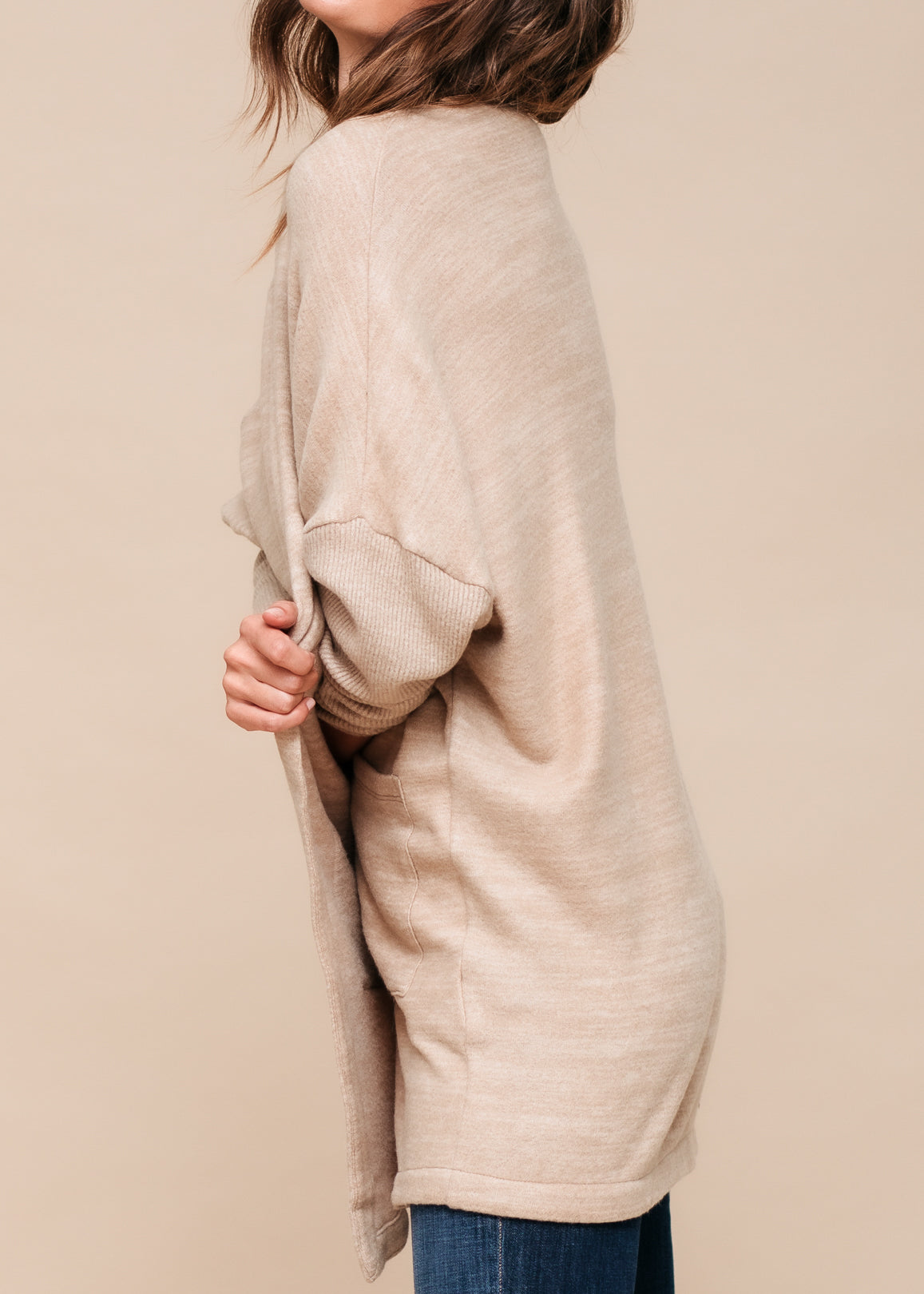 A stylish Women's Basic Cardigan in Camel color, showcasing its soft fabric and relaxed fit, perfect for layering.