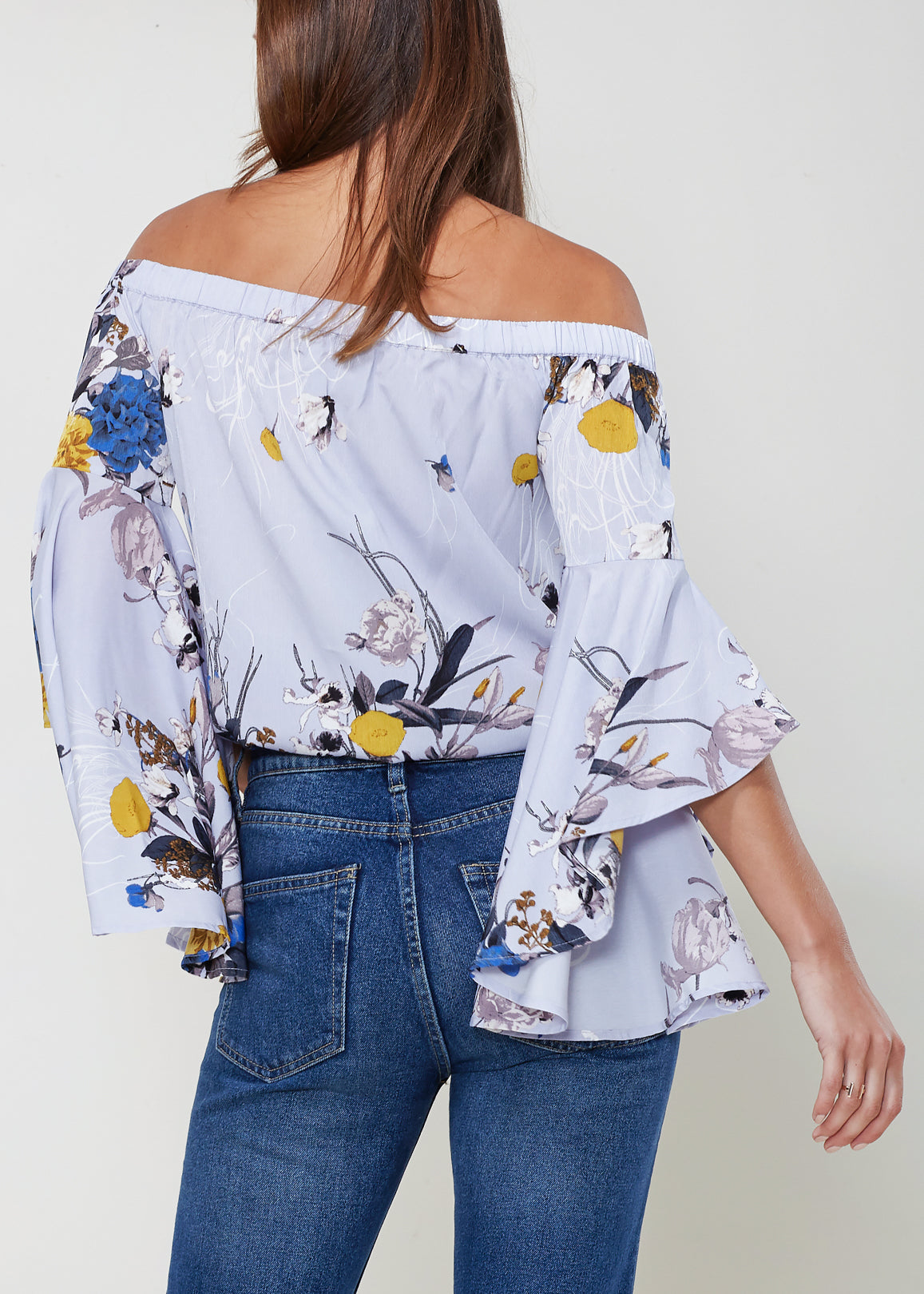 A stylish Women's Bell Sleeve Off The Shoulder Top featuring flowing bell sleeves and a comfortable off-the-shoulder design, made from 100% polyester.