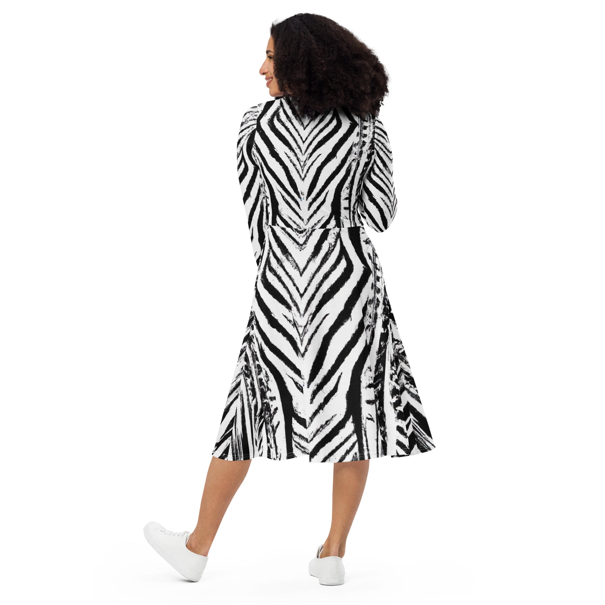 Womens Long Sleeve Midi Dress featuring a black and white native print, showcasing its fitted waist, flared bottom, and side pockets.