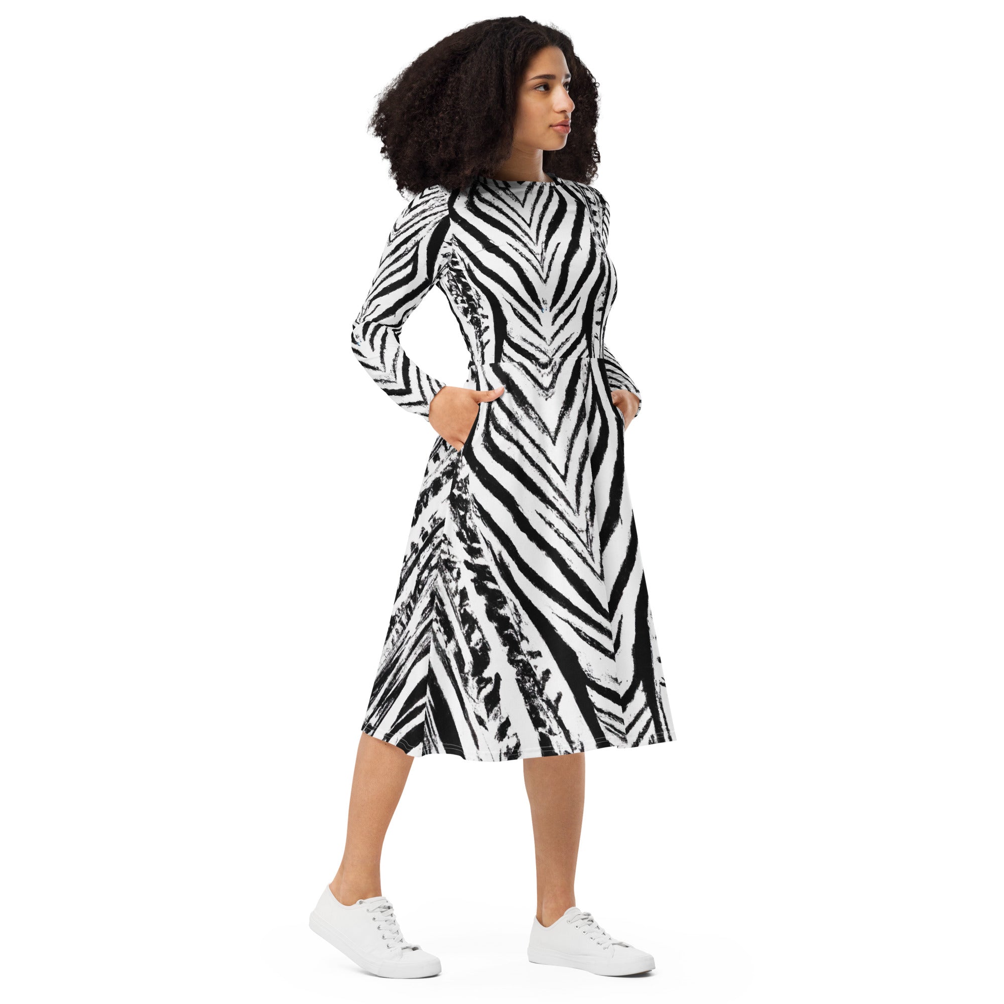 Womens Long Sleeve Midi Dress featuring a black and white native print, showcasing its fitted waist, flared bottom, and side pockets.