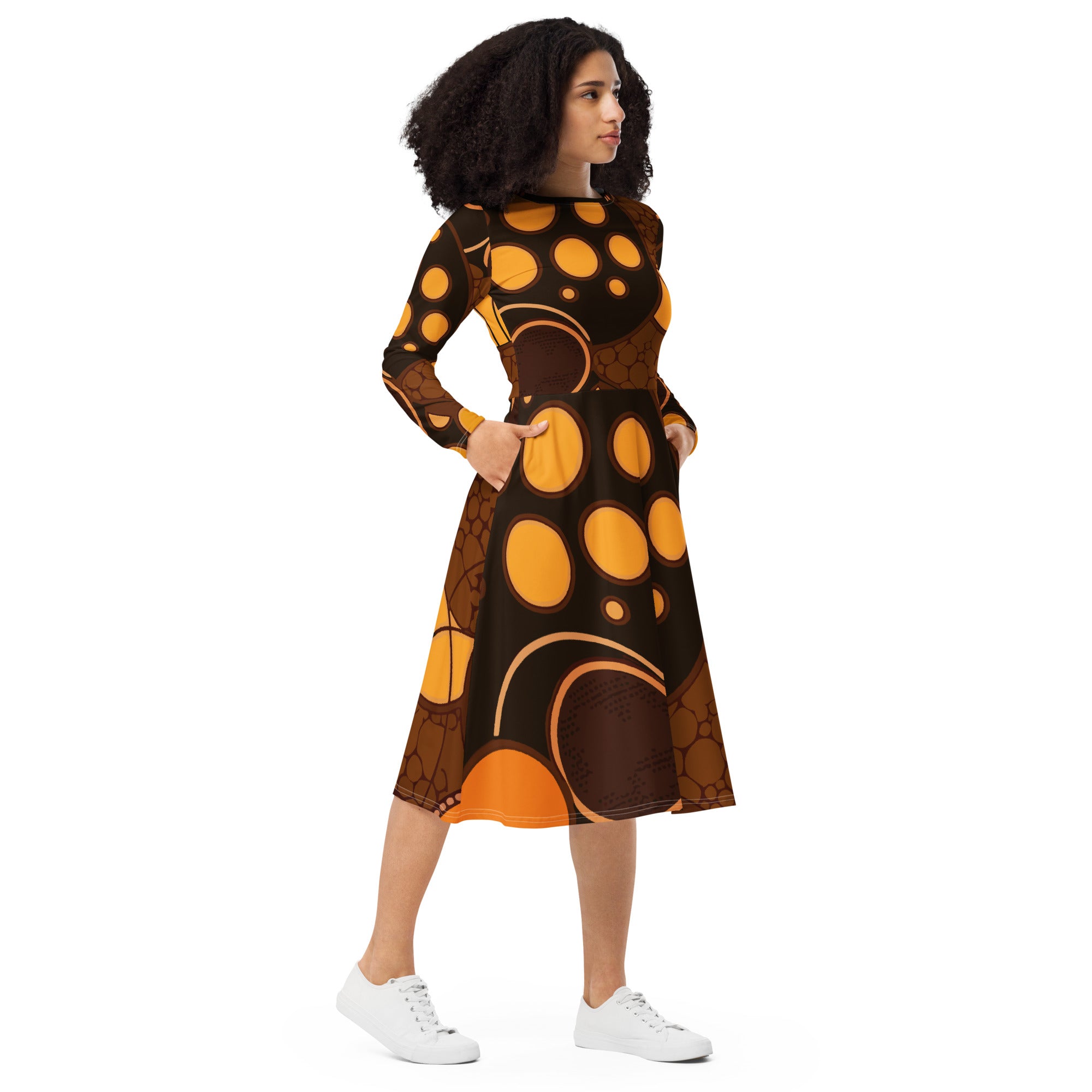 Womens Long Sleeve Midi Dress in orange brown spotted print, featuring a fitted waist, flared bottom, and side pockets.