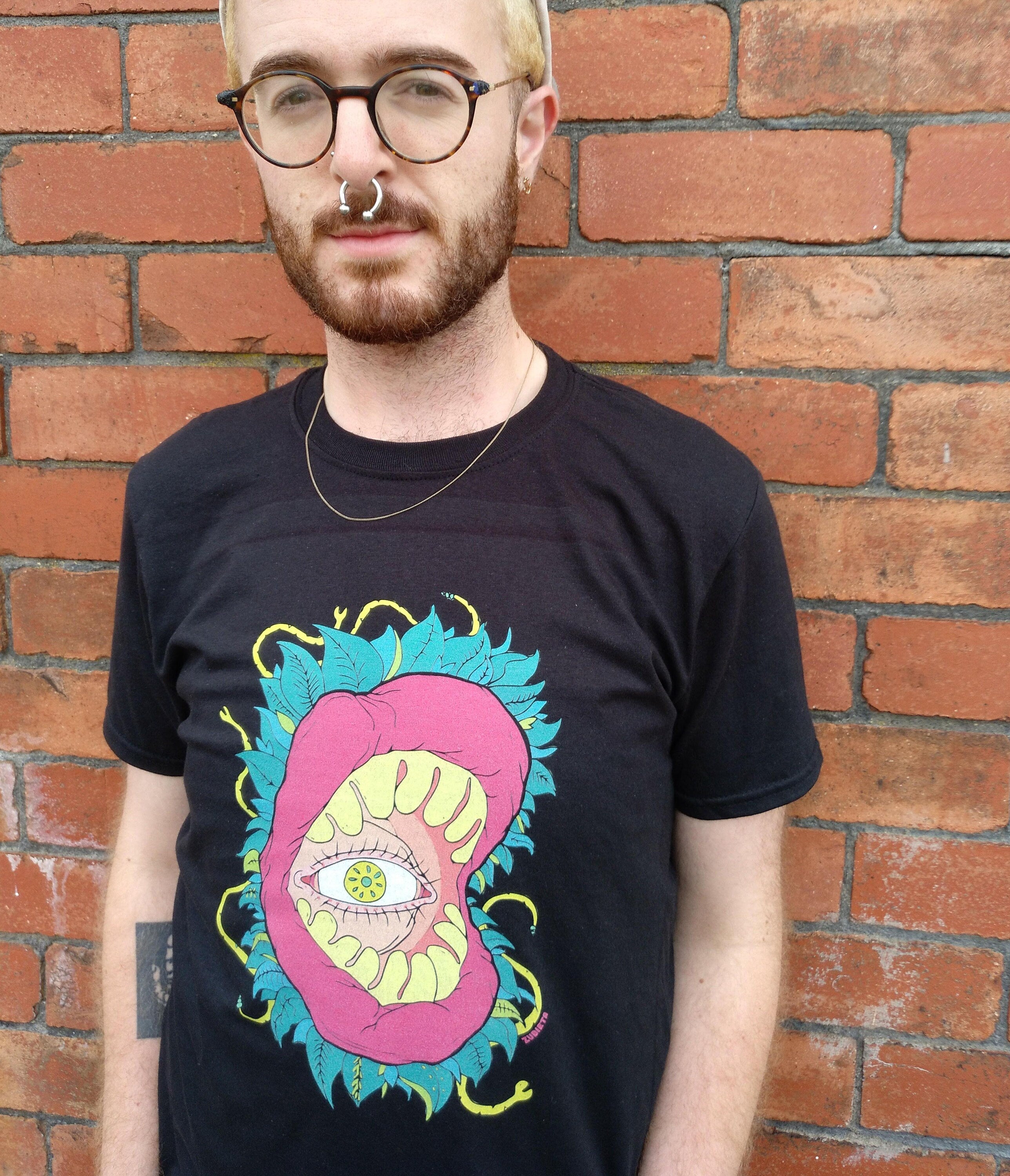 All Seeing Eye T-shirt featuring a vibrant design inspired by the subconscious and tropical jungles, made from 100% cotton.