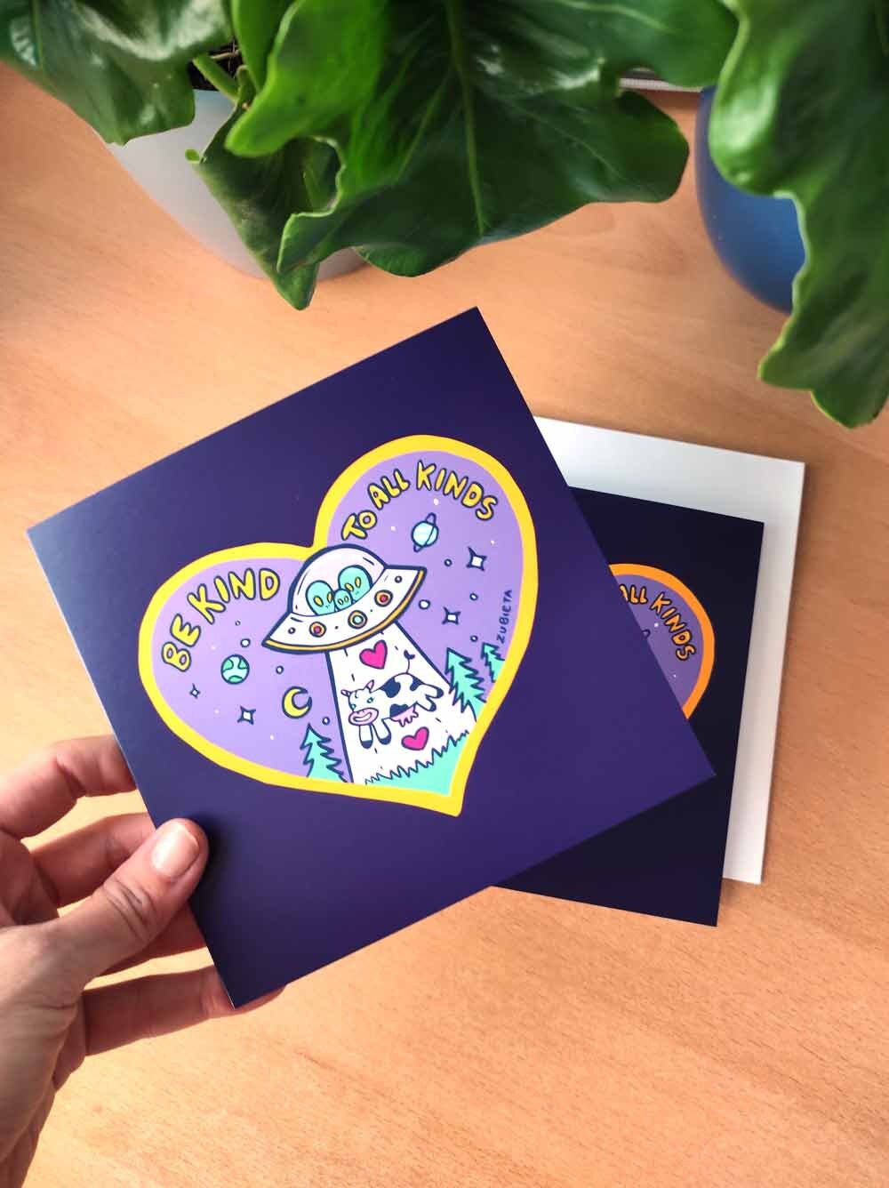 A vibrant 'Be Kind To All Kinds' greeting card featuring psychedelic digital art, with a square envelope and a sticker included.