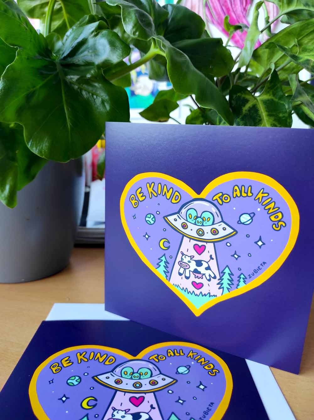 A vibrant 'Be Kind To All Kinds' greeting card featuring psychedelic digital art, with a square envelope and a sticker included.