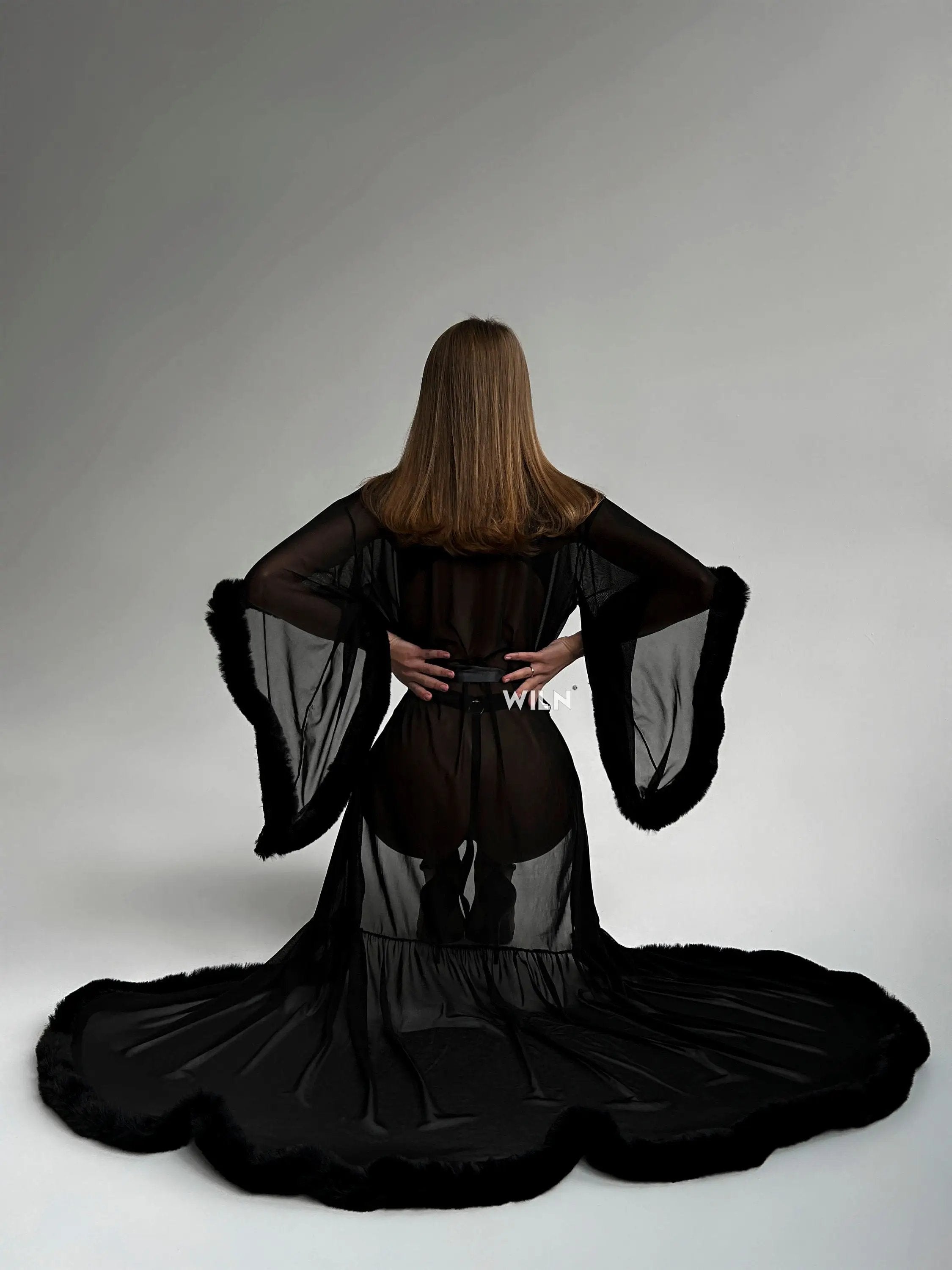 Elegant Burlesque Black Dress with faux fur trimmings and sheer mesh, showcasing a flattering silhouette and wide sleeves.