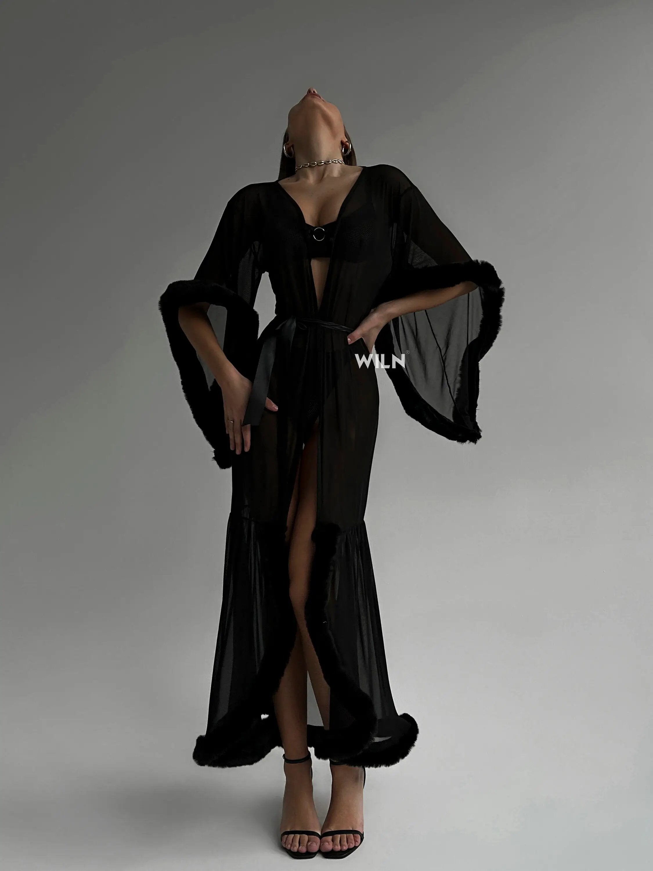 Elegant Burlesque Black Dress with faux fur trimmings and sheer mesh, showcasing a flattering silhouette and wide sleeves.