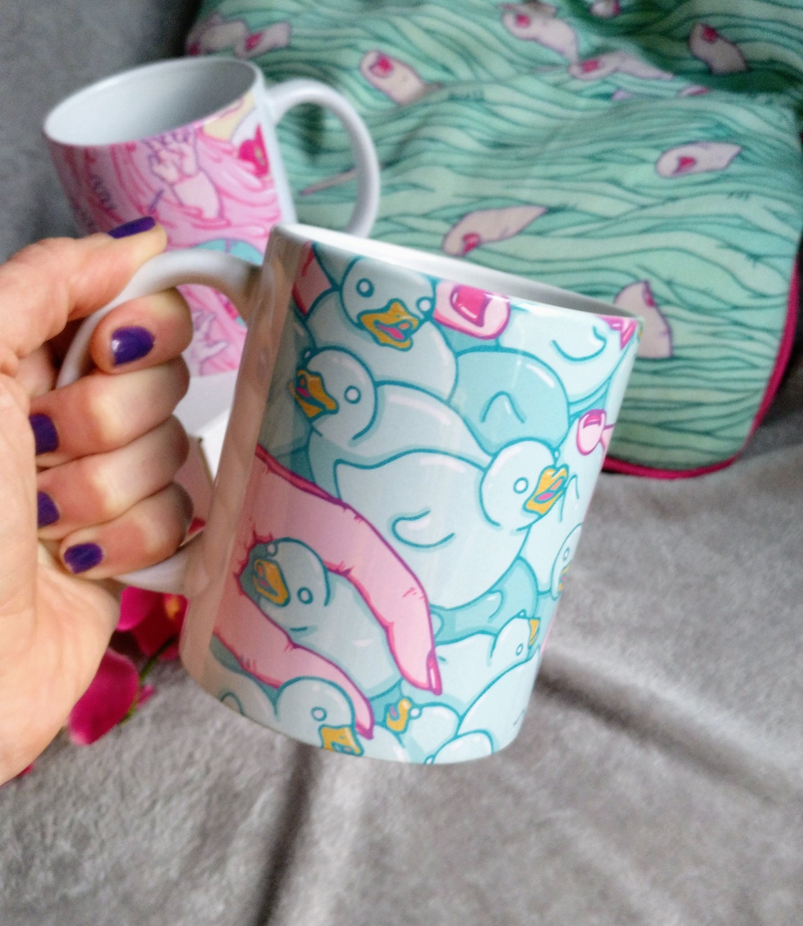 A high-quality ceramic mug featuring colorful Duckies artwork, perfect for enjoying beverages.