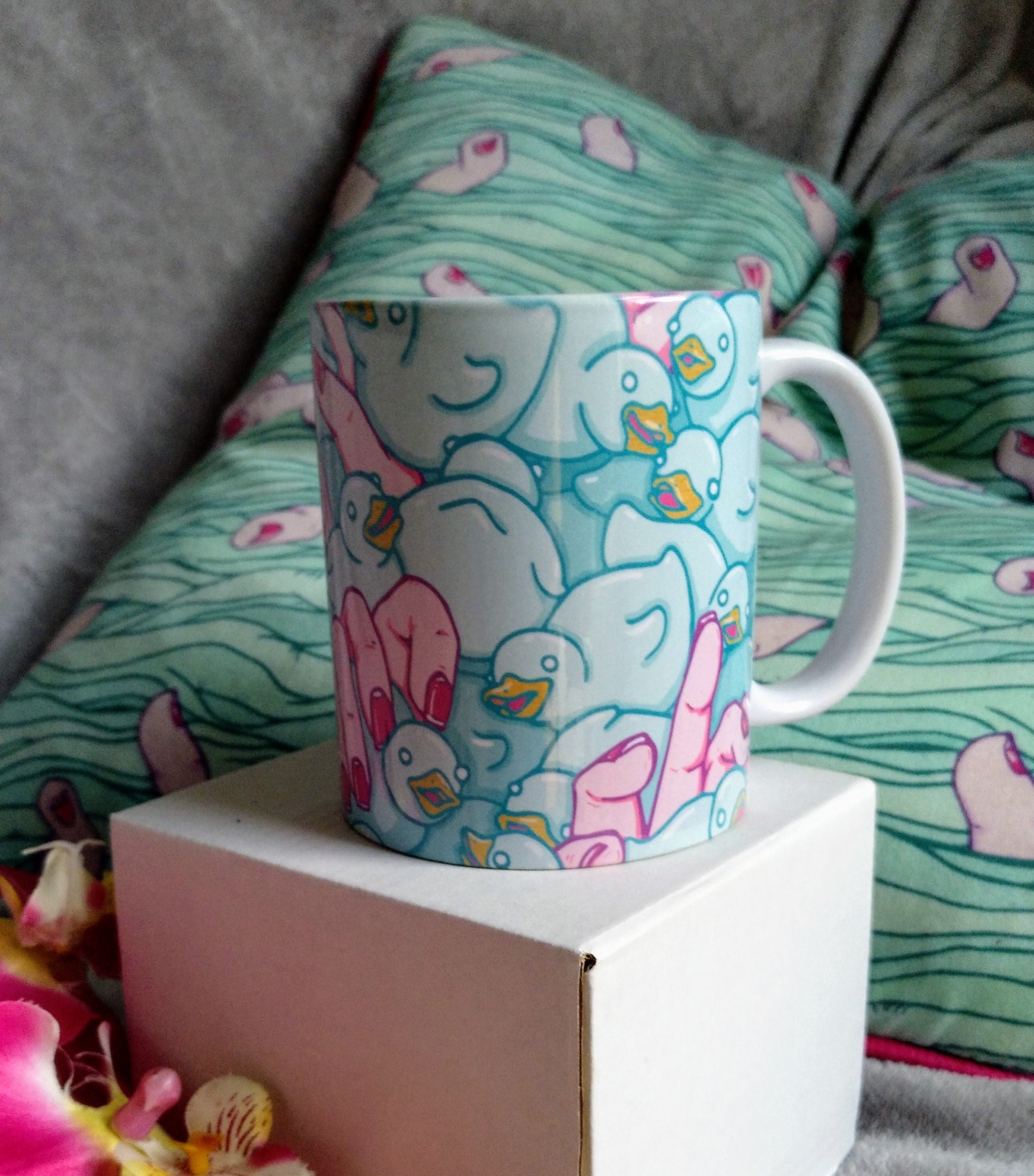 A high-quality ceramic mug featuring colorful Duckies artwork, perfect for enjoying beverages.