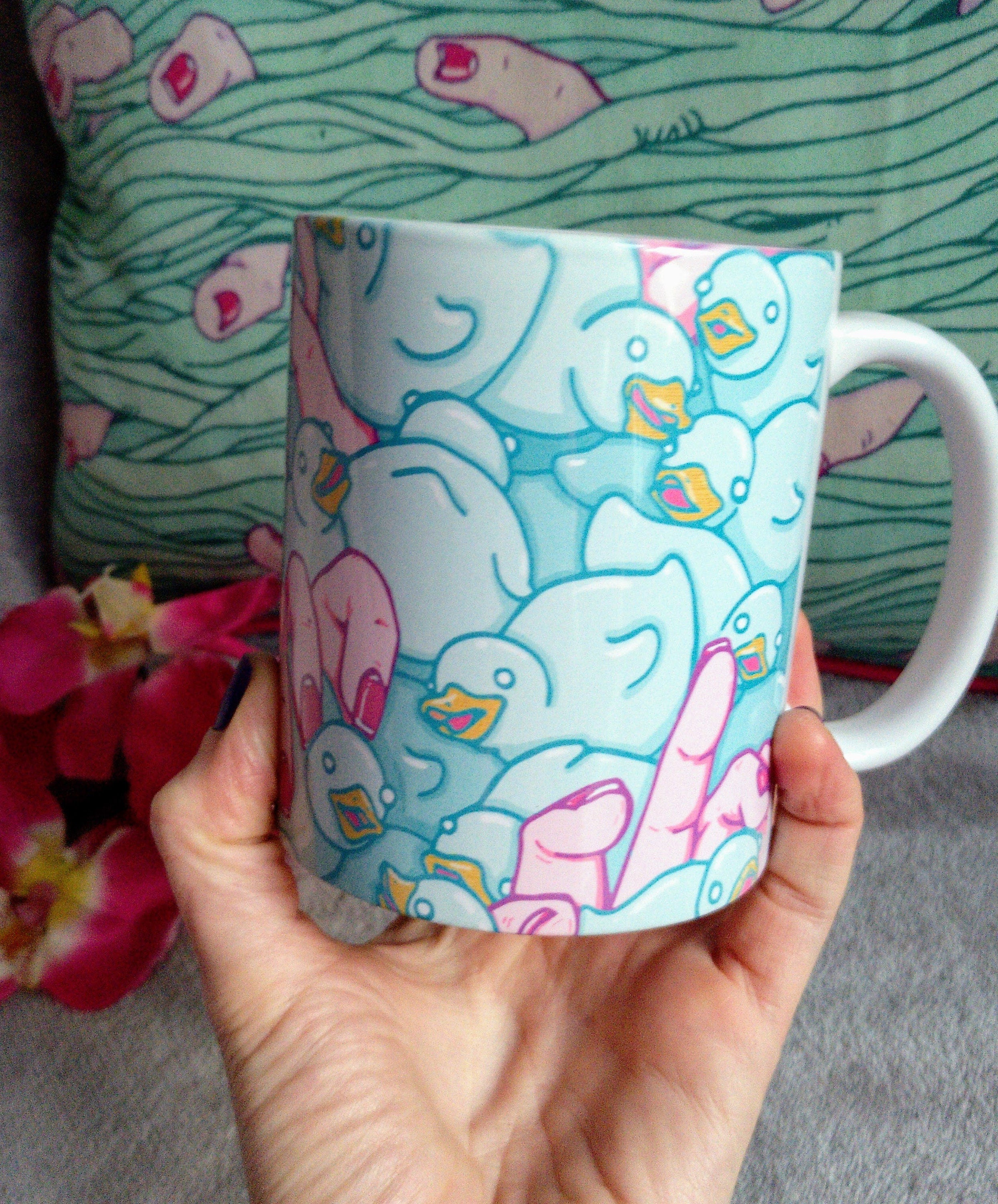 A high-quality ceramic mug featuring colorful Duckies artwork, perfect for enjoying beverages.