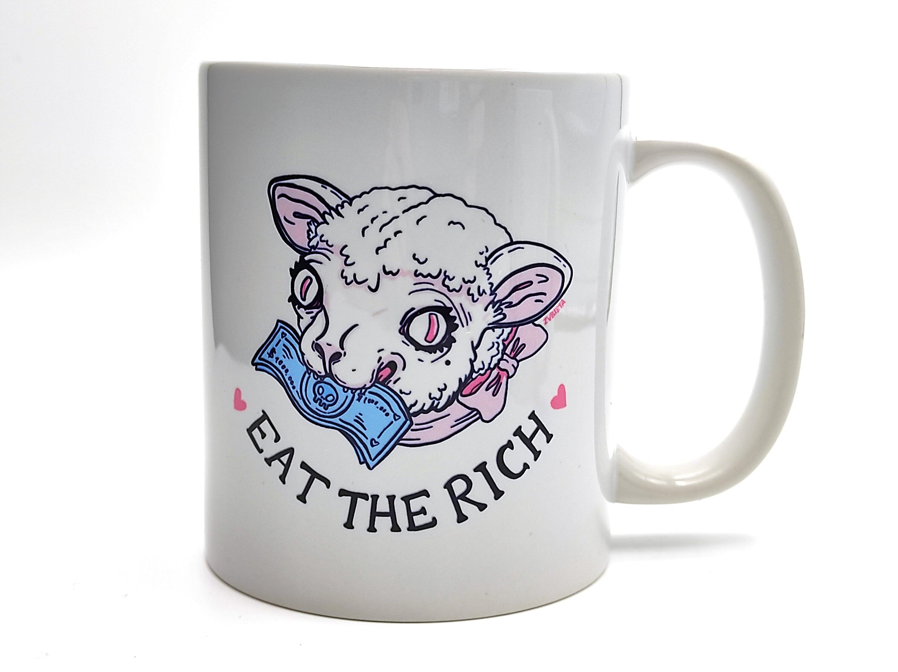 Ceramic mug with the phrase 'Eat The Rich' printed in bold, featuring a high-quality design and durable finish.