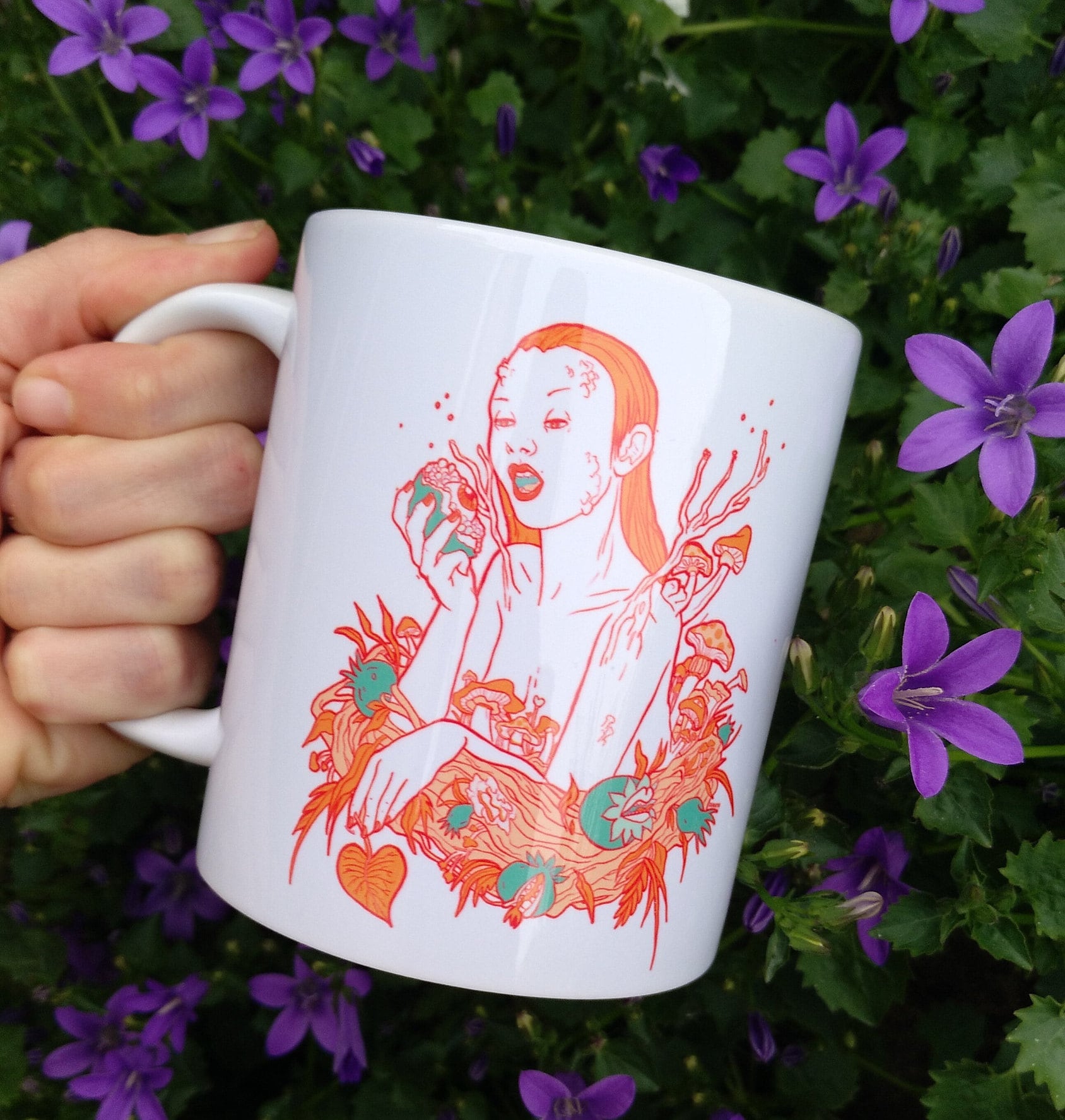 Ceramic mug featuring artwork inspired by the Greek goddess Persephone, showcasing vibrant colors and intricate designs.