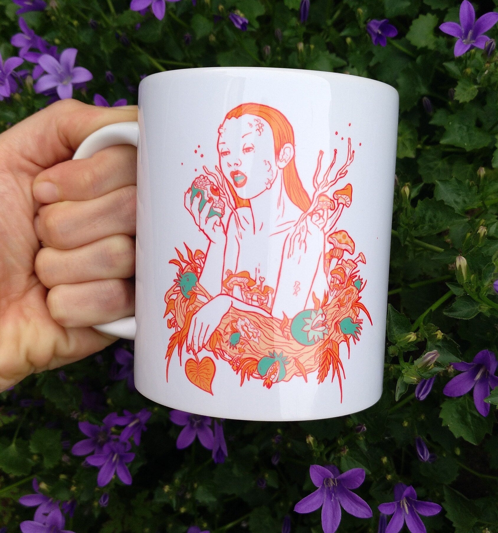 Ceramic mug featuring artwork inspired by the Greek goddess Persephone, showcasing vibrant colors and intricate designs.