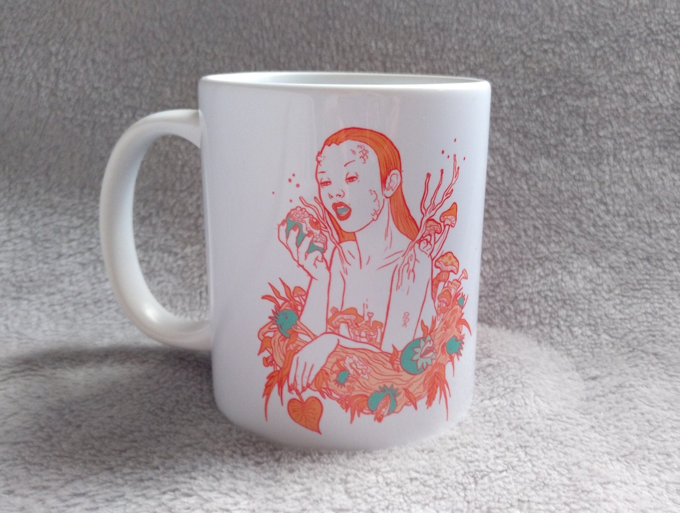 Ceramic mug featuring artwork inspired by the Greek goddess Persephone, showcasing vibrant colors and intricate designs.